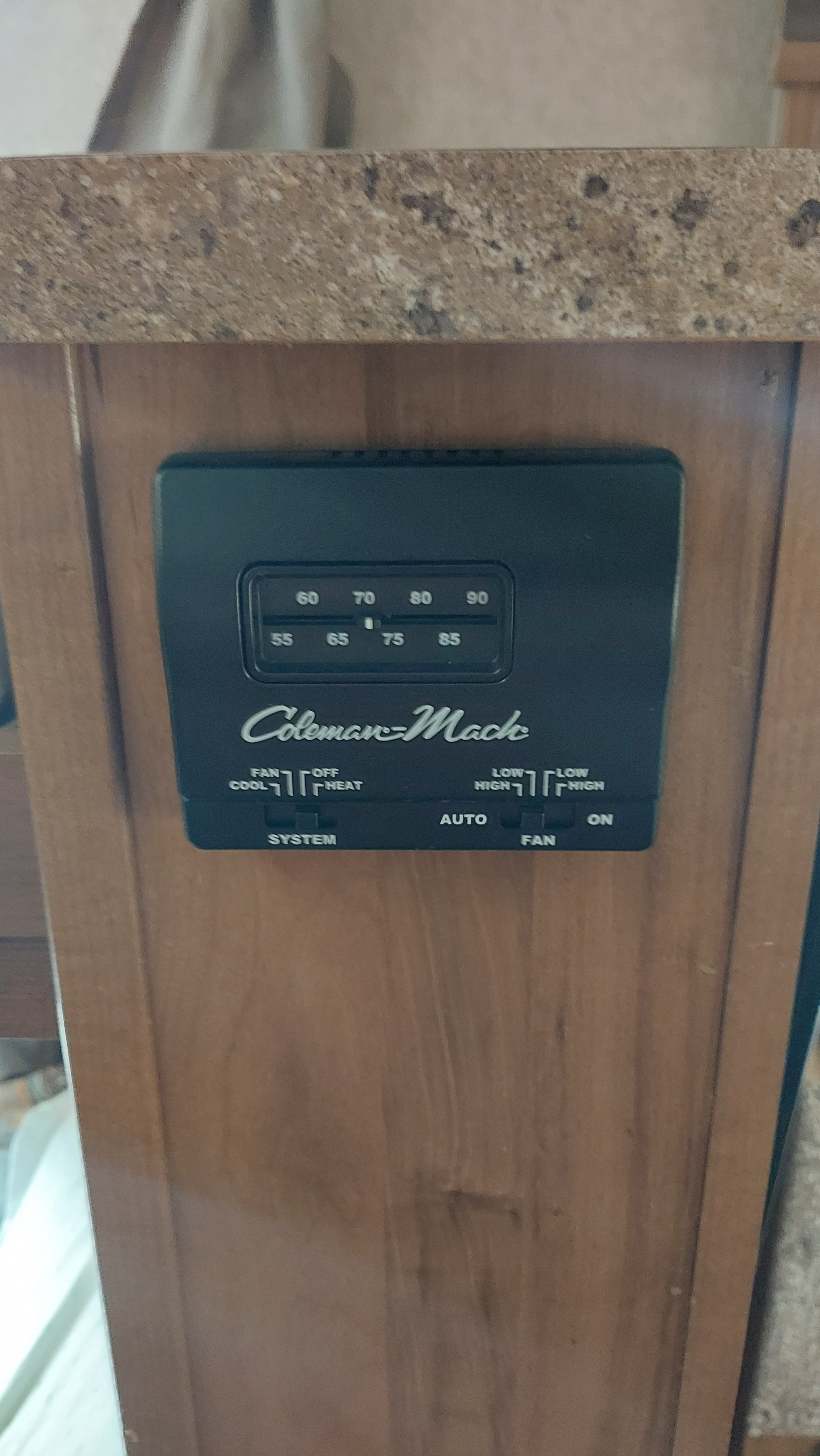 This Coleman-Mack thermostat in an RV rental controls temperature (55-90) and fan settings (cool, heat) for comfort.. Other Other 2016