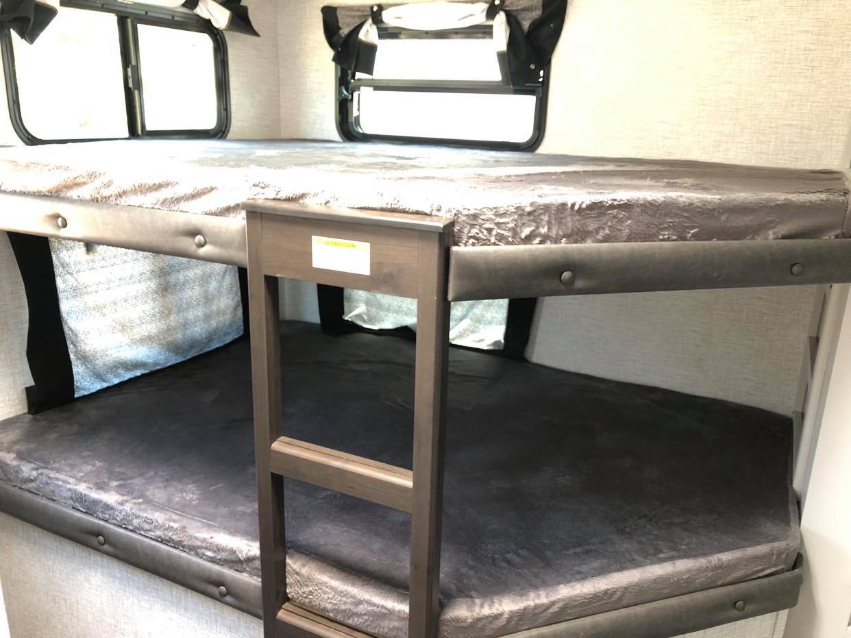 This RV rental offers cozy bunk beds for multiple sleepers, complete with windows & an access ladder.. Keystone Bullet 2021