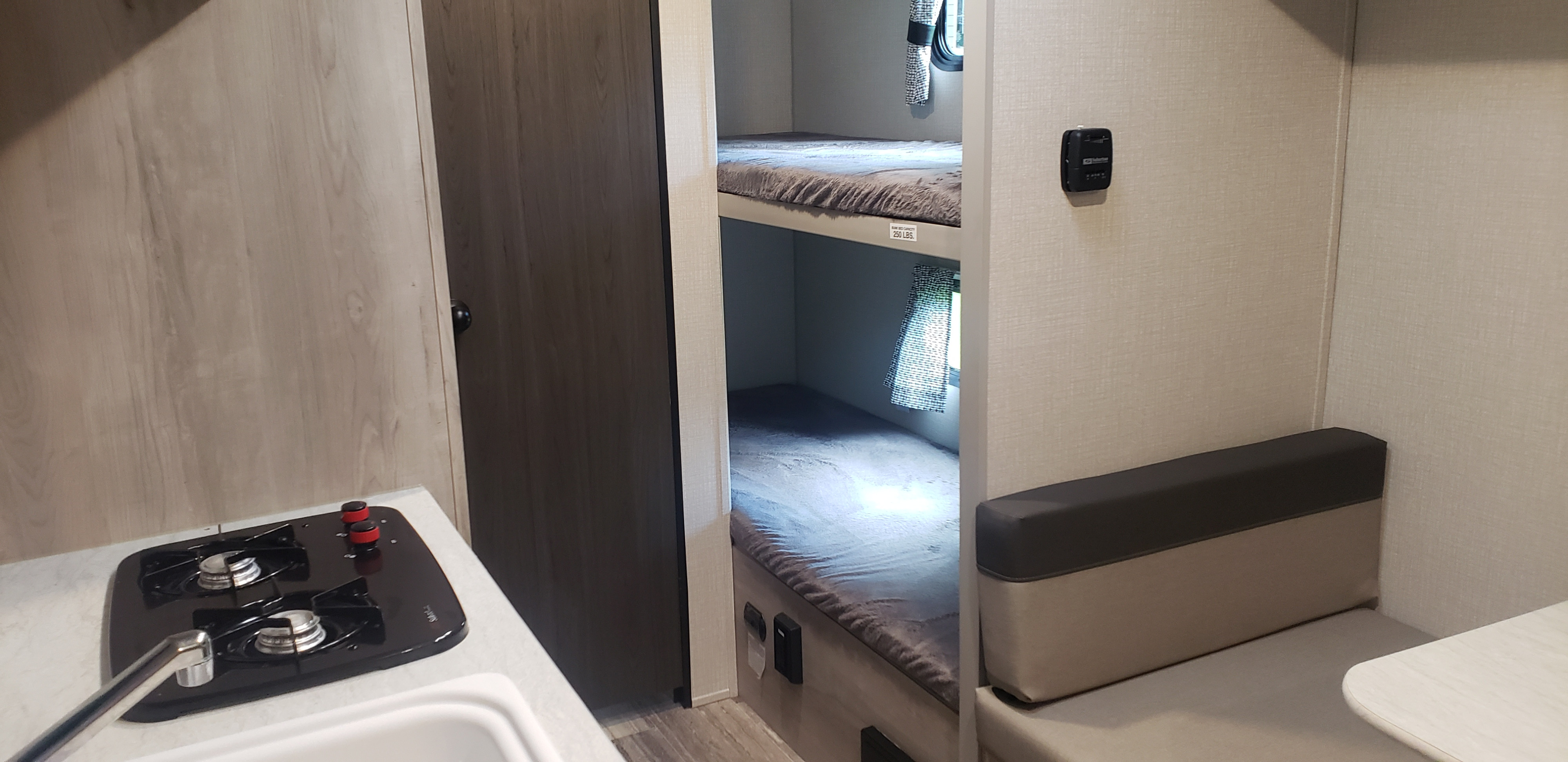 RV rental with a compact kitchenette, cozy bunk beds (250 lbs capacity), and a dinette area.. KZ Sportsmen 180BH 2021