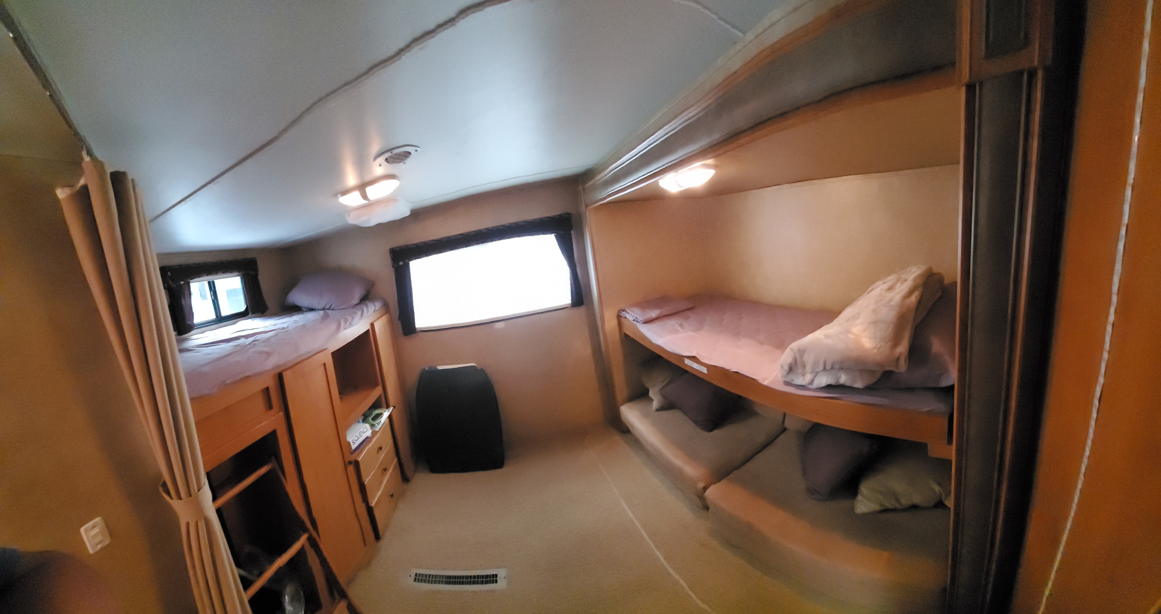 RV rental bunk room: Features multiple bunk beds on left and right, windows, storage cabinetry, and ceiling lights, ideal for families.. Cruiser Rv Corp Shadow Cruiser 2012