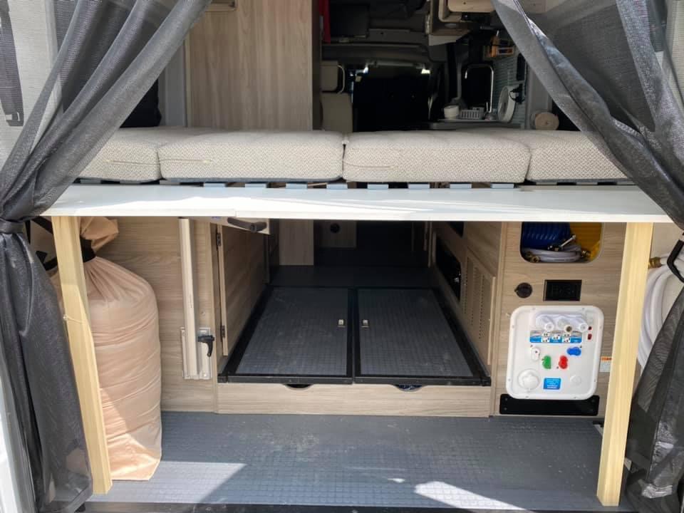 This RV rental offers a cozy elevated bed and spacious rear storage with essential utility connections. Ready for travel.. Winnebago Solis 2021