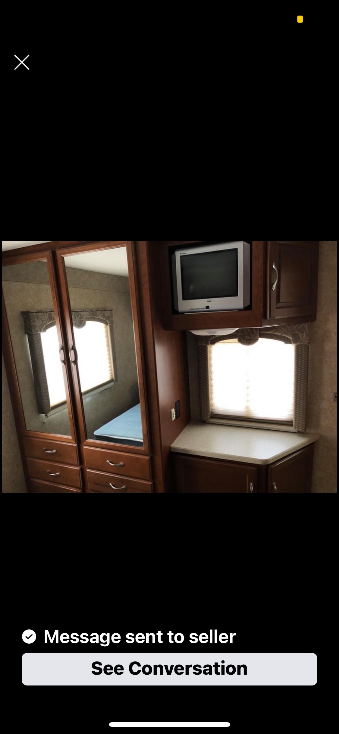 RV rental: compact bedroom with mirrored closet doors, a CRT TV, and counter space by the window.. Dutchmen Dutchmen 2008