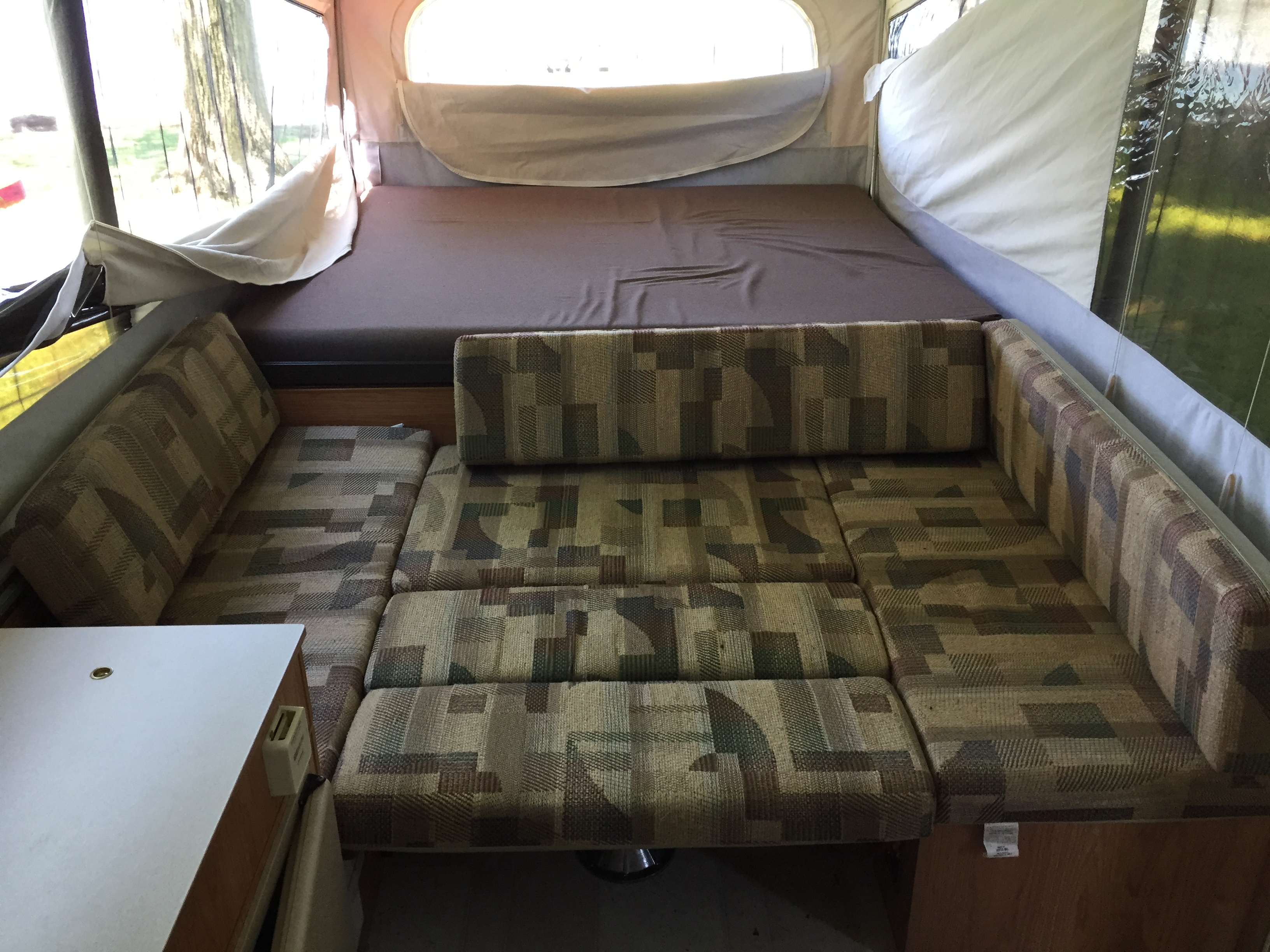 Queen-size bed. Cushions can be arranged for seating or more sleeping options. Storage space underneath.. Jayco Qwest 2002