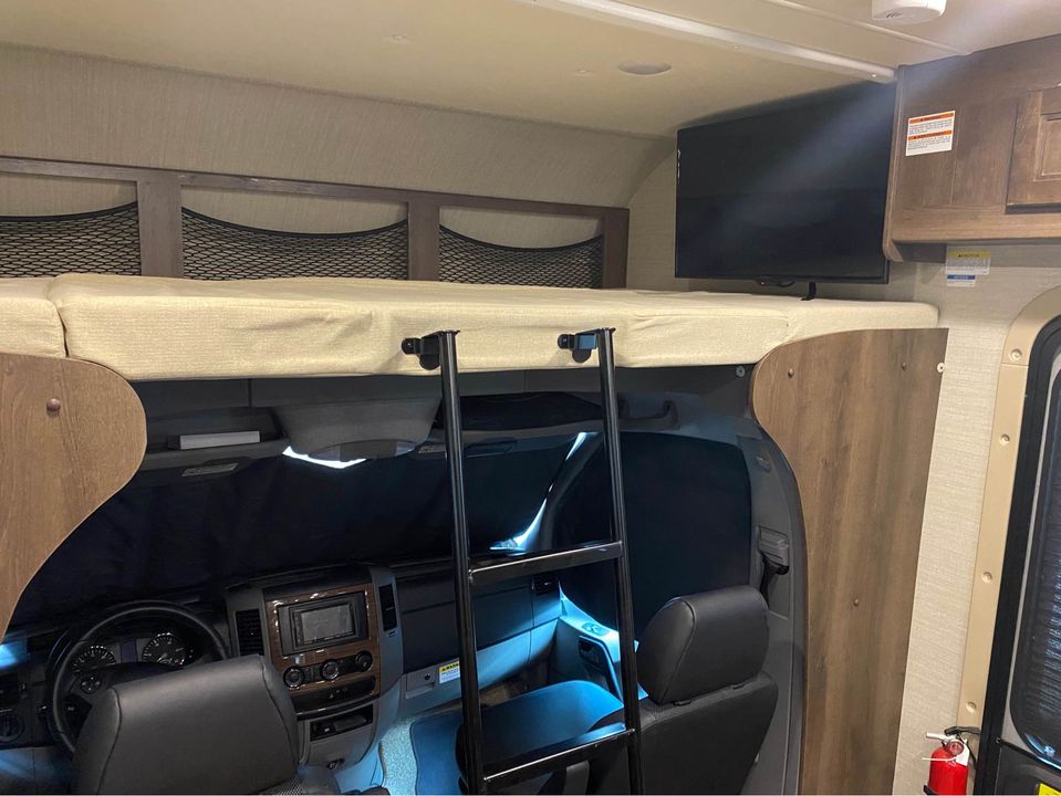 Full sized bed in bunk above cab, with TV!. Jayco Melbourne 2019