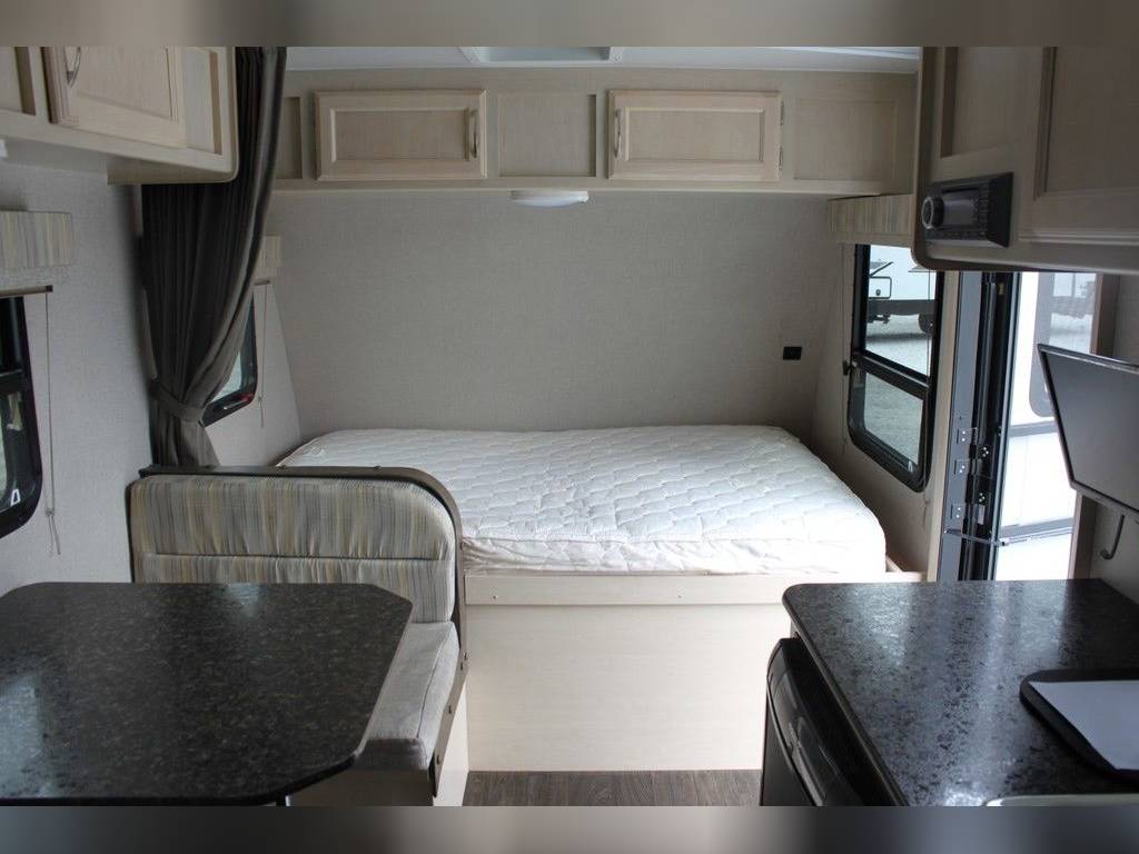 This RV rental interior features a comfortable bed, dinette, overhead cabinets, and an entertainment system.. Winnebago Micro Minnie 2019