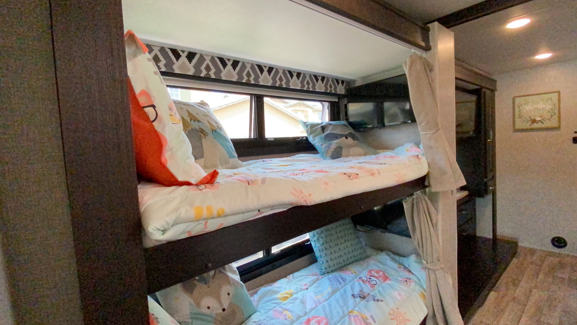 Cozy RV rental bunk beds, adorned with cute kids' bedding, offer a snug travel experience. Ideal for family adventures.. Other Other 2022