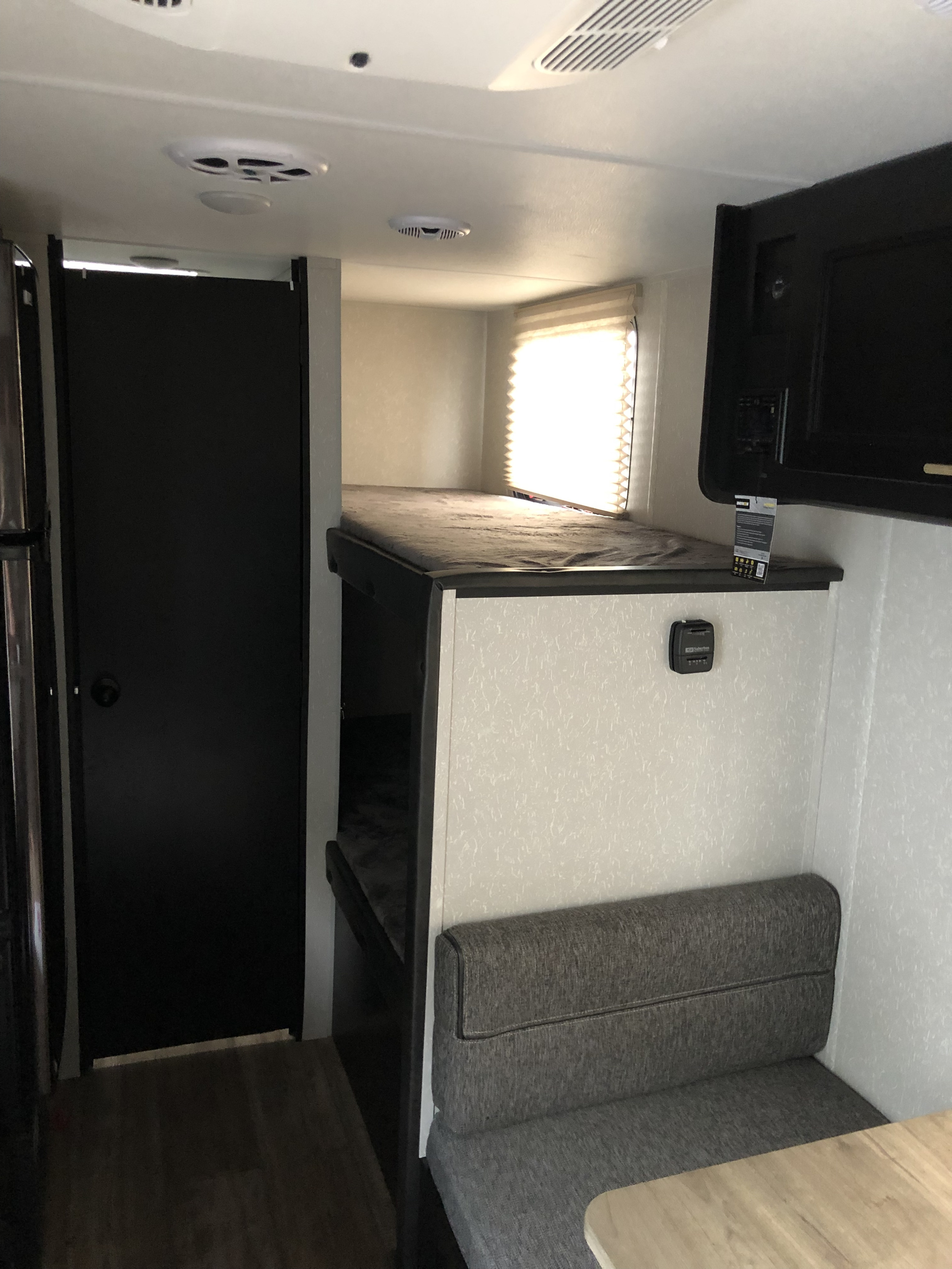 Tour this RV rental's cozy interior, showcasing comfy bunk beds, a practical dinette, and compact amenities.. Forest River Wolf Pup 2021