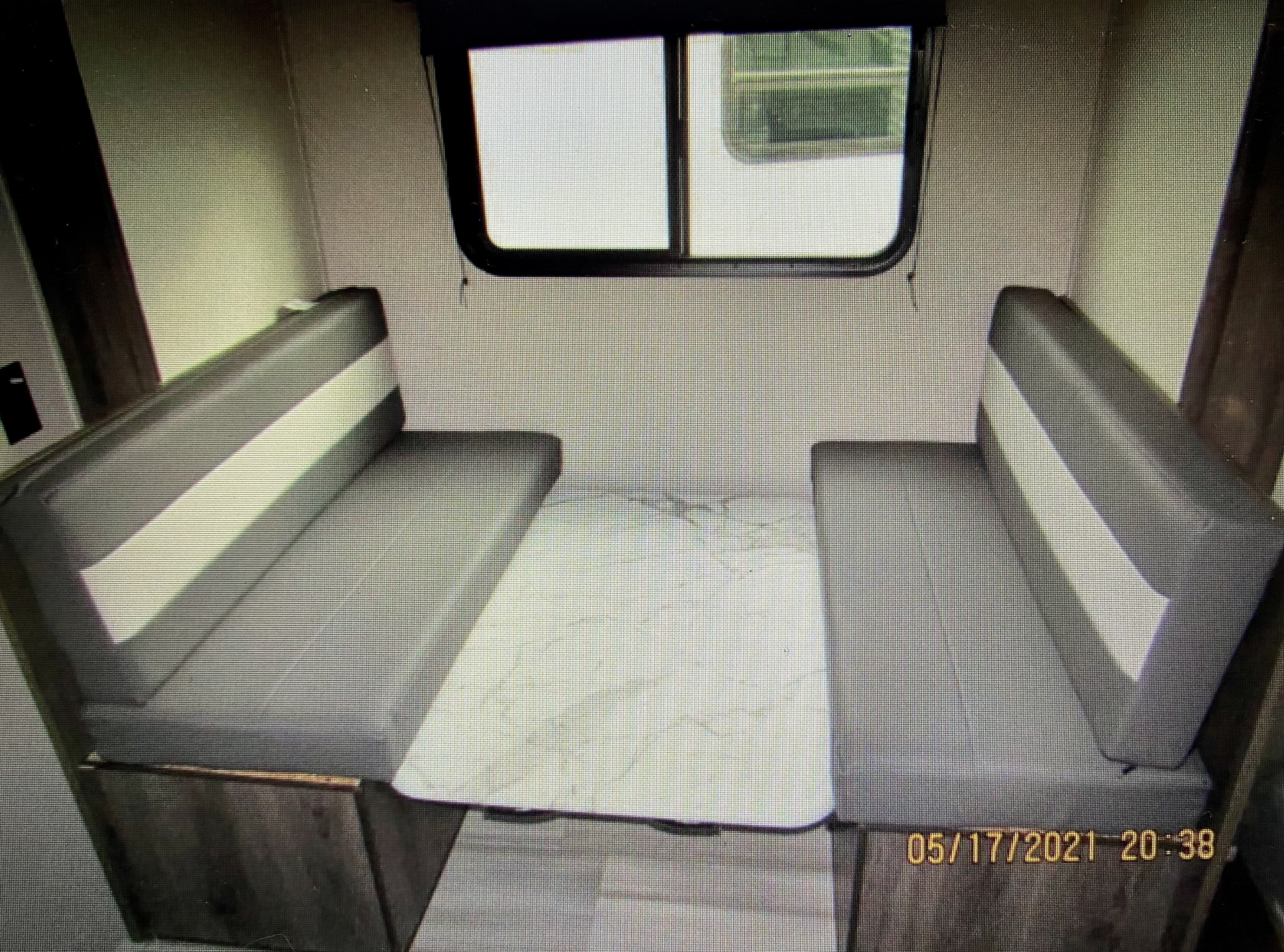 RV rental: Interior view of a clean dinette with grey benches and a table, ready for your next road trip adventure.. Coachmen 17BH 2021