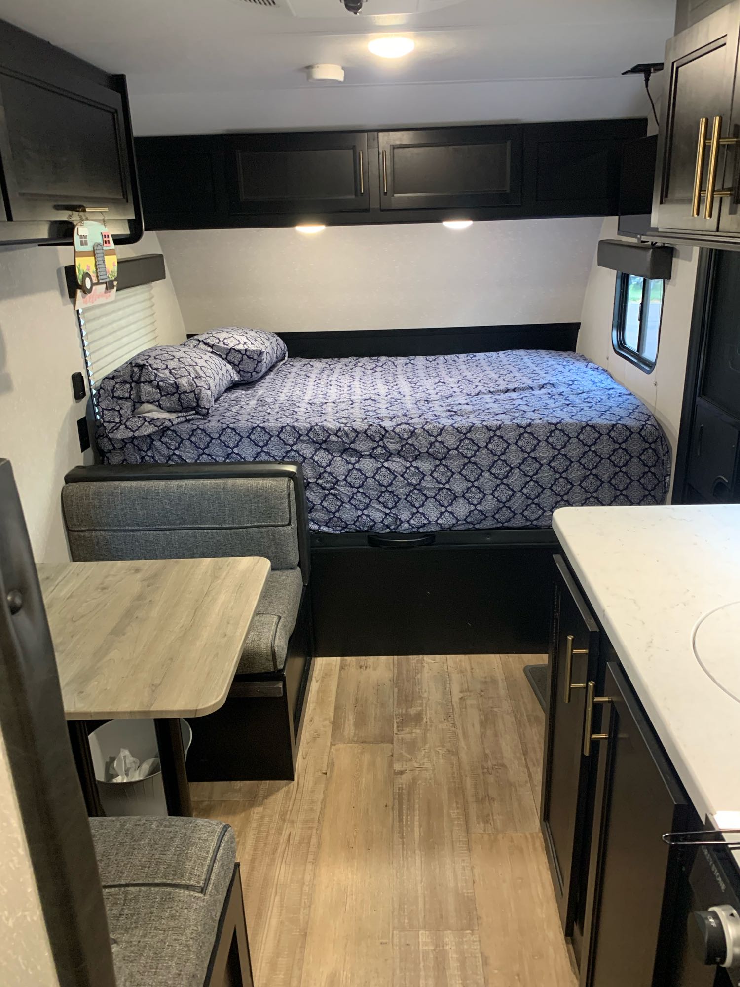 Cozy RV rental interior with a comfy bed, dinette, and kitchen area, showing the practical layout for travel.. Forest River Cherokee Wolf Pup 2021
