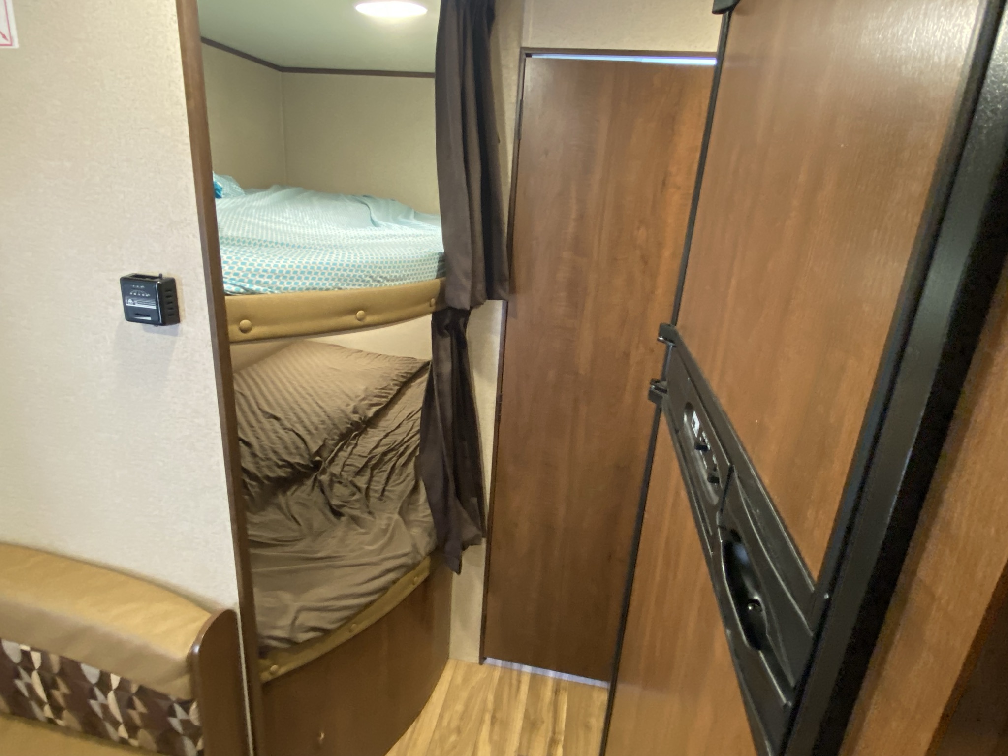 RV rental interior with stacked bunk beds and a control panel, offering a comfortable sleeping area.. Jayco Jay Flight 2016