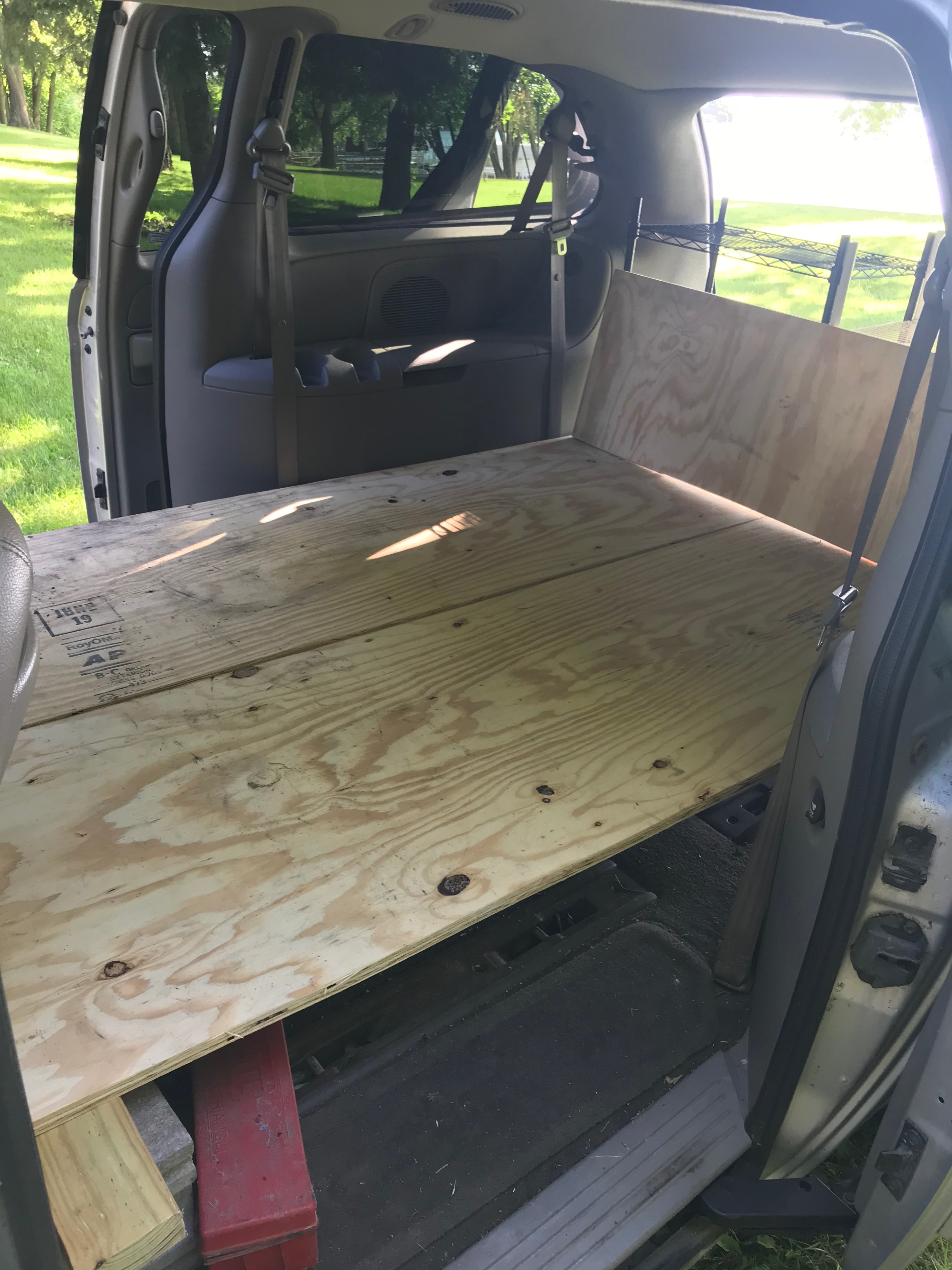 Without the cushions shows bed in full size mode. Plywood is split converted into a single bed by slipping one plywood sheet on the other.. Dodge Grand Caravan 2001
