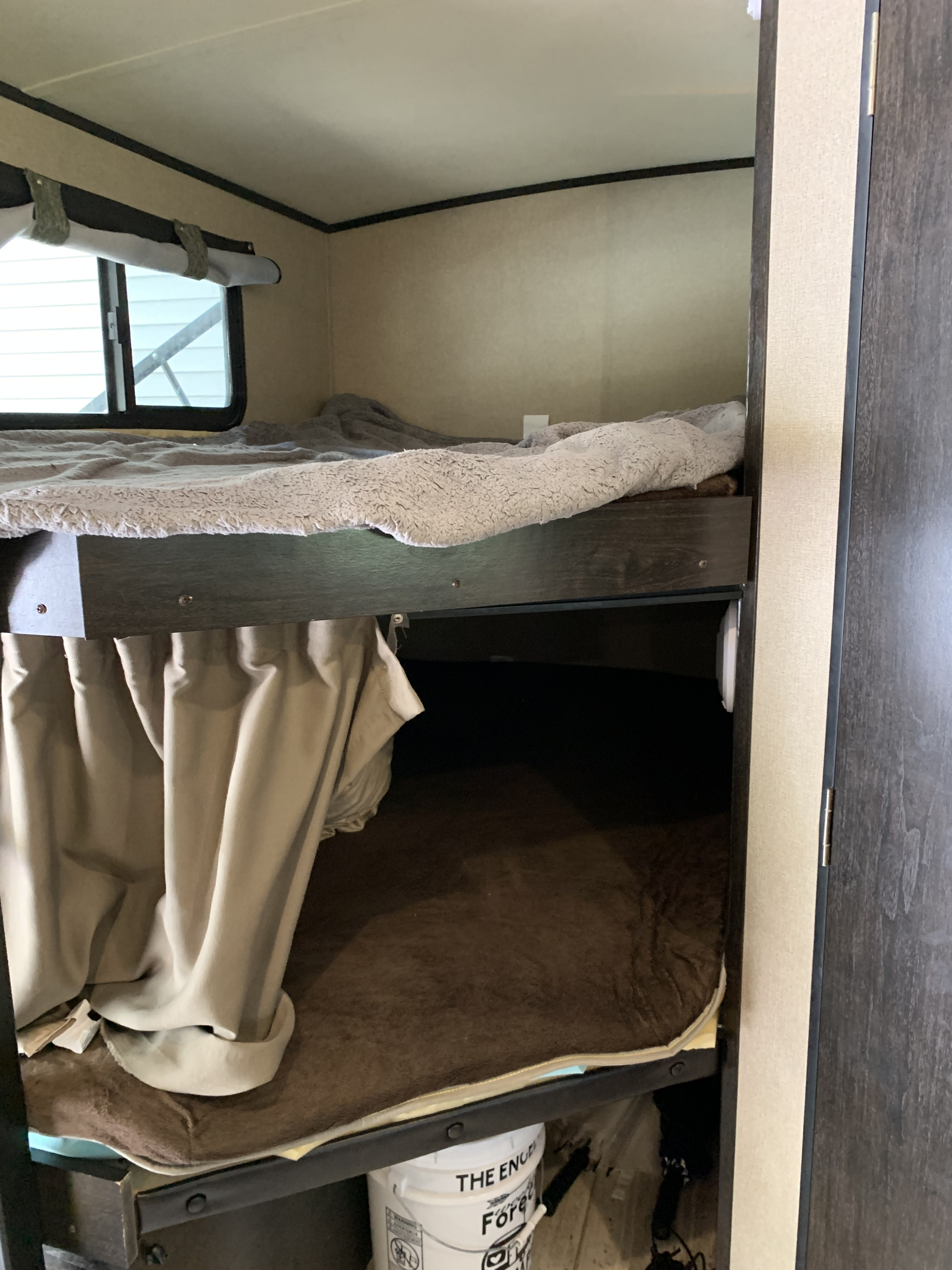 Cozy RV rental bunk beds with soft blankets, privacy curtains, and a window for camping adventures.. Grand Design Other 2016