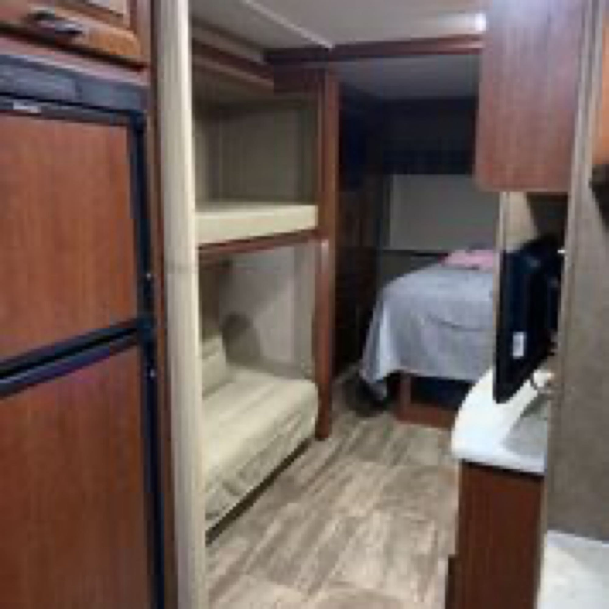 RV rental with bunk beds, main bedroom, fridge, and TV. A functional and comfortable interior for travelers.. Forest River Sunseeker 2017