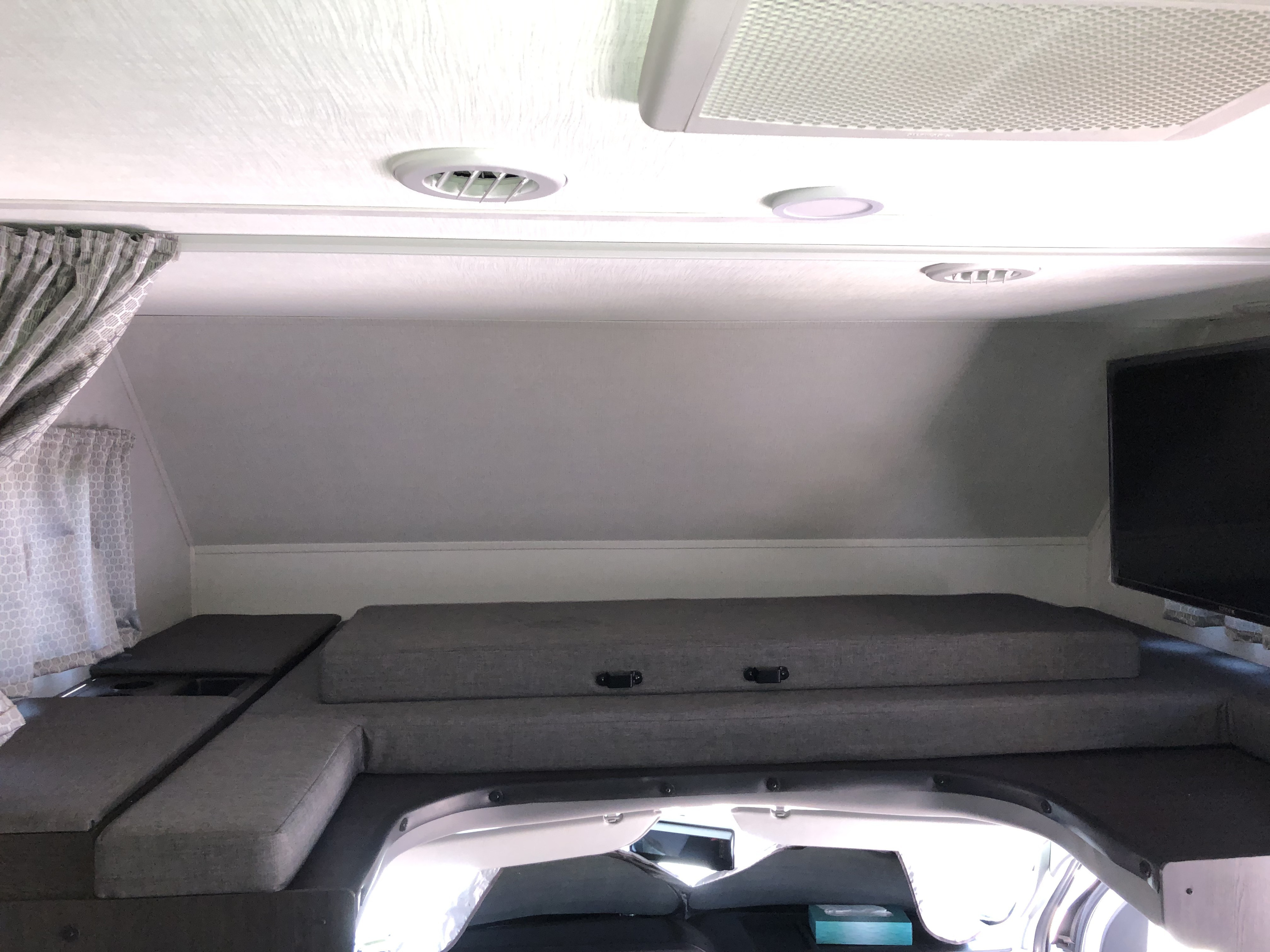 Experience comfort in this RV rental's cab-over bunk, featuring a comfy mattress, storage, and entertainment for your trip.. Forest River Sunseeker 2021