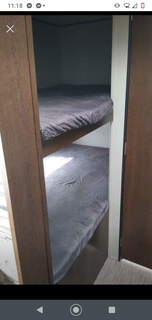 RV rental bunk beds: Two cozy bunks with grey bedding, providing a compact sleeping area inside the RV for your trip.. Prime Time Avenger 2020