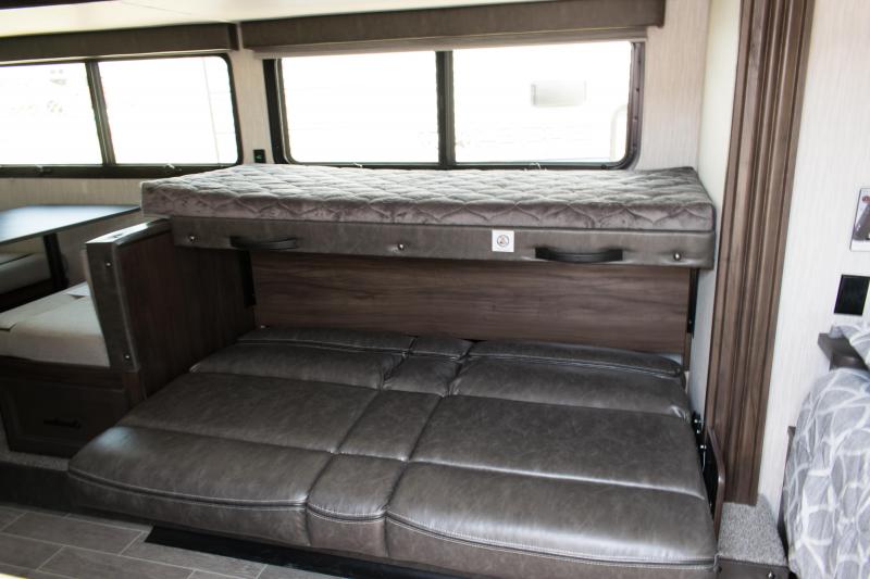 RV rental interior: convertible sofa, bunk bed, and dinette. Flexible sleeping for your next camping adventure.. Forest River Wolf Pup 2020