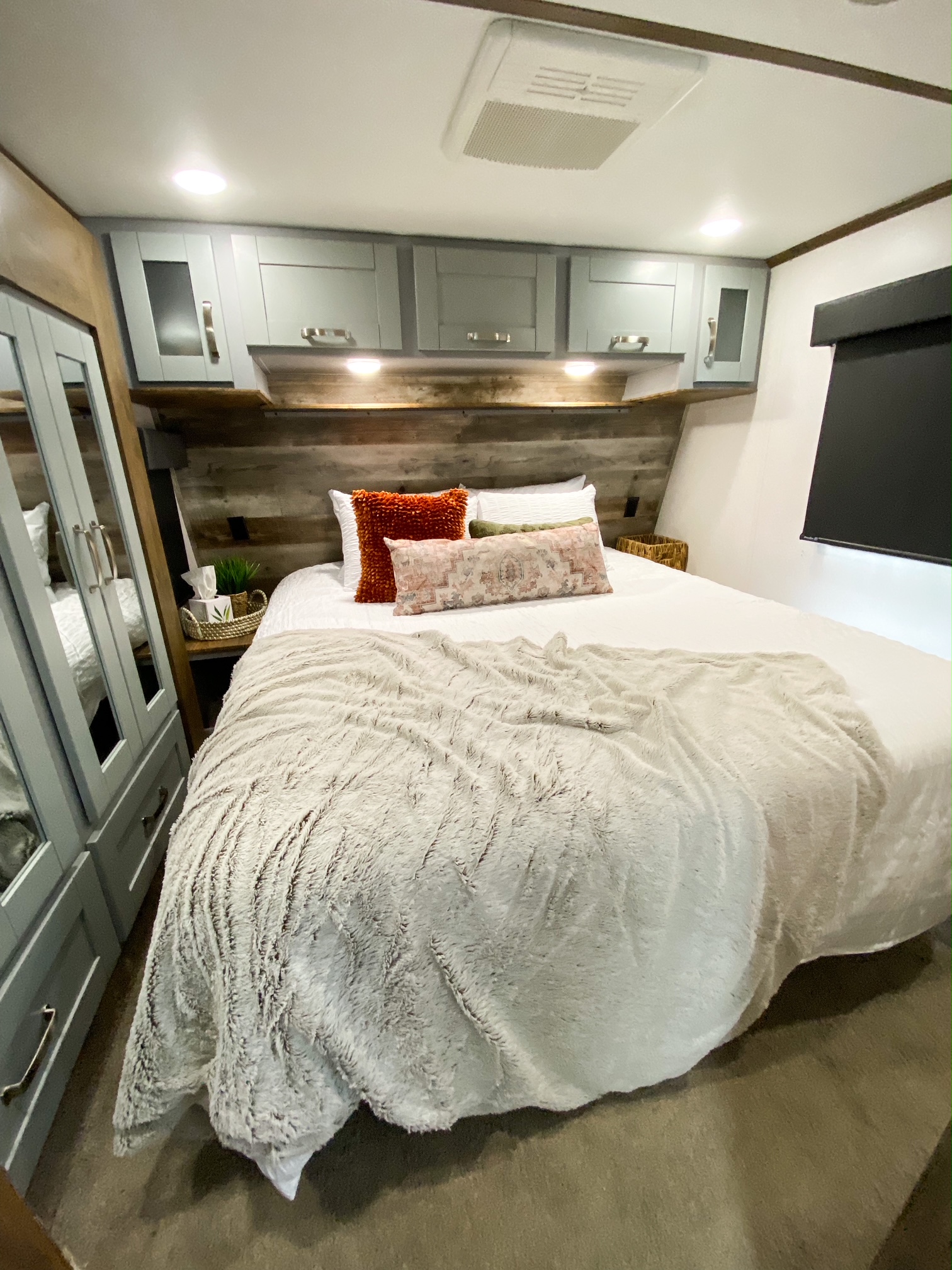 Cozy RV rental bedroom with modern cabinets, plush bedding, and ample storage. Perfect for your next adventure.. Keystone Fuzion 2020
