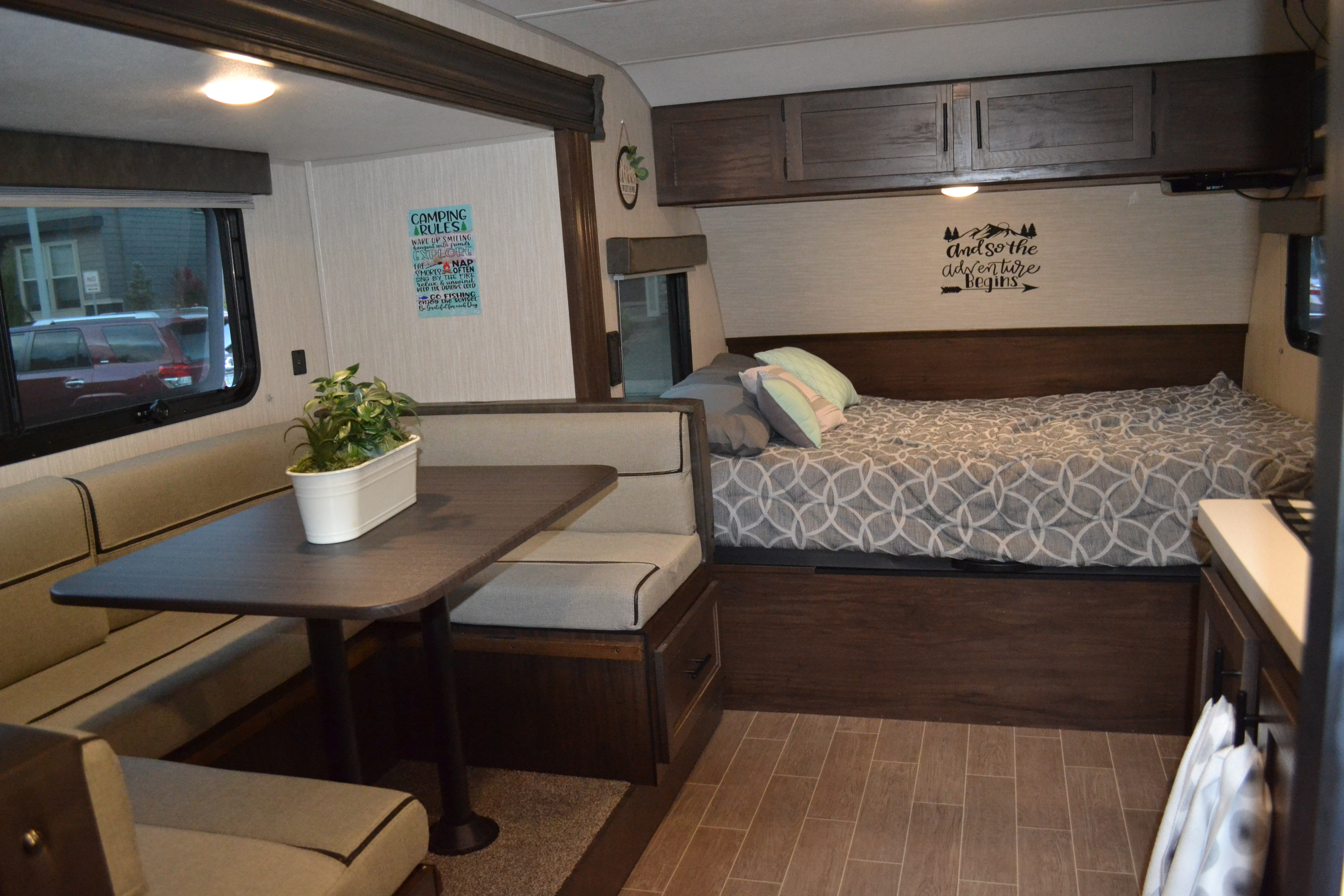 Spacious RV rental interior with a comfy dinette, bed, and overhead cabinets, perfect for camping trips.. Forest River Cherokee Wolf Pup 2020