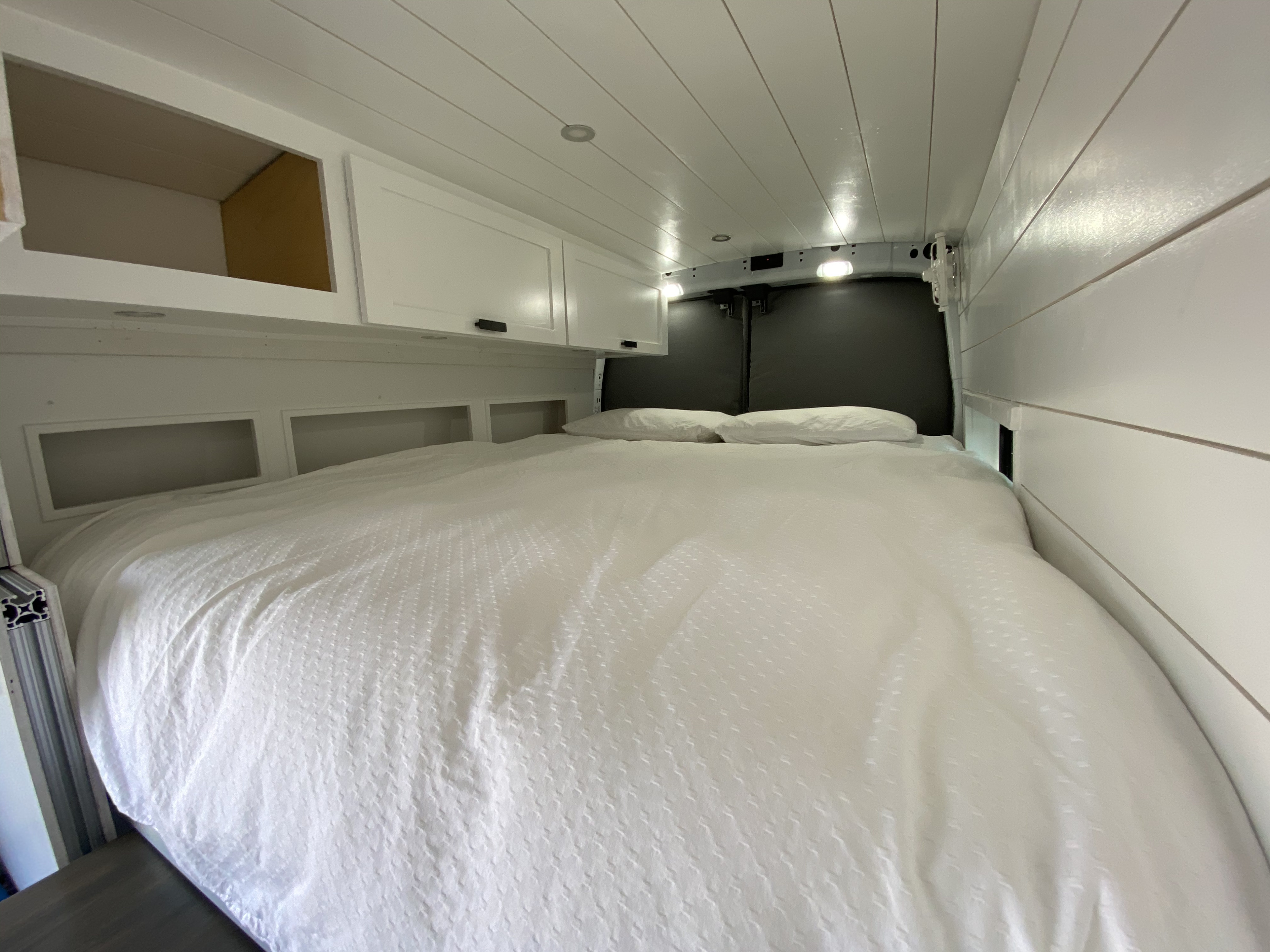 We went all out on bedding.  Queen bed offers plenty of room for tall guests, plush, fresh sheets, and pillows. Pillows and bed wrapped in barrier. . Ford Transit 2020