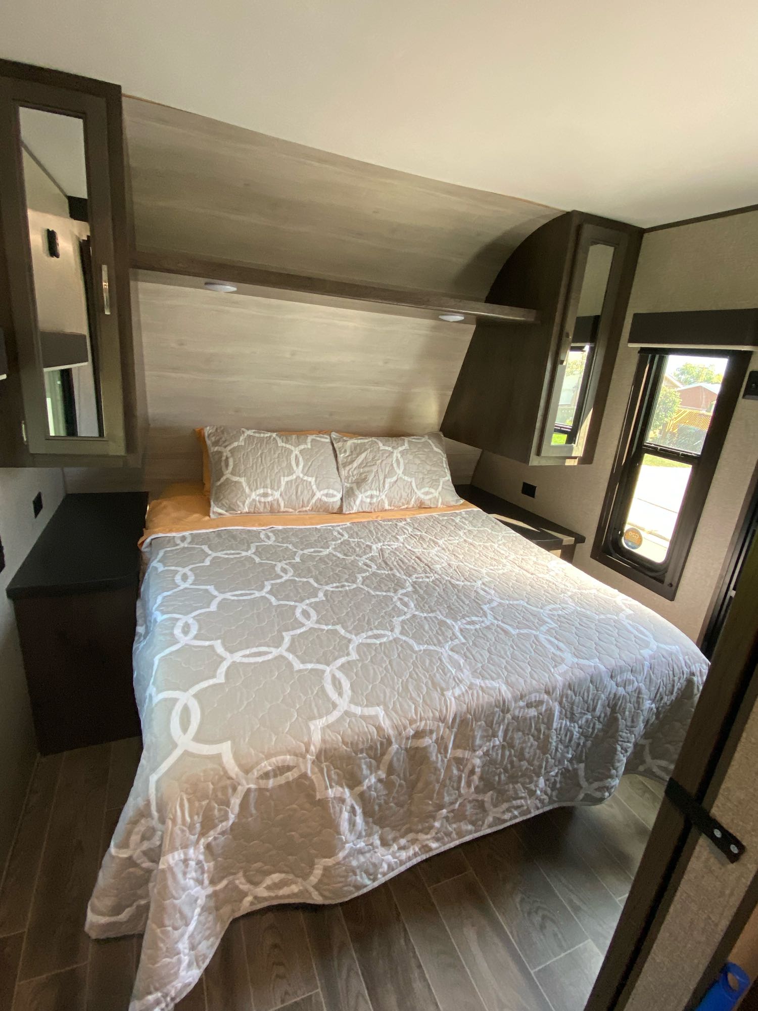 A comfortable RV bedroom with a patterned quilt and ample storage. Book your RV rental adventure today!. Jayco Jay Flight SLX Rocky Mountain Edition 2021