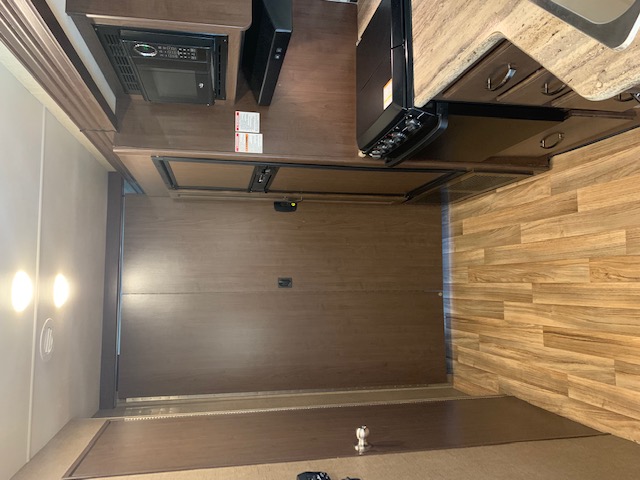 This RV rental features a well-equipped kitchen with microwave, stove, refrigerator, and wood-look flooring.. Thor Motor Coach A.C.E 2017