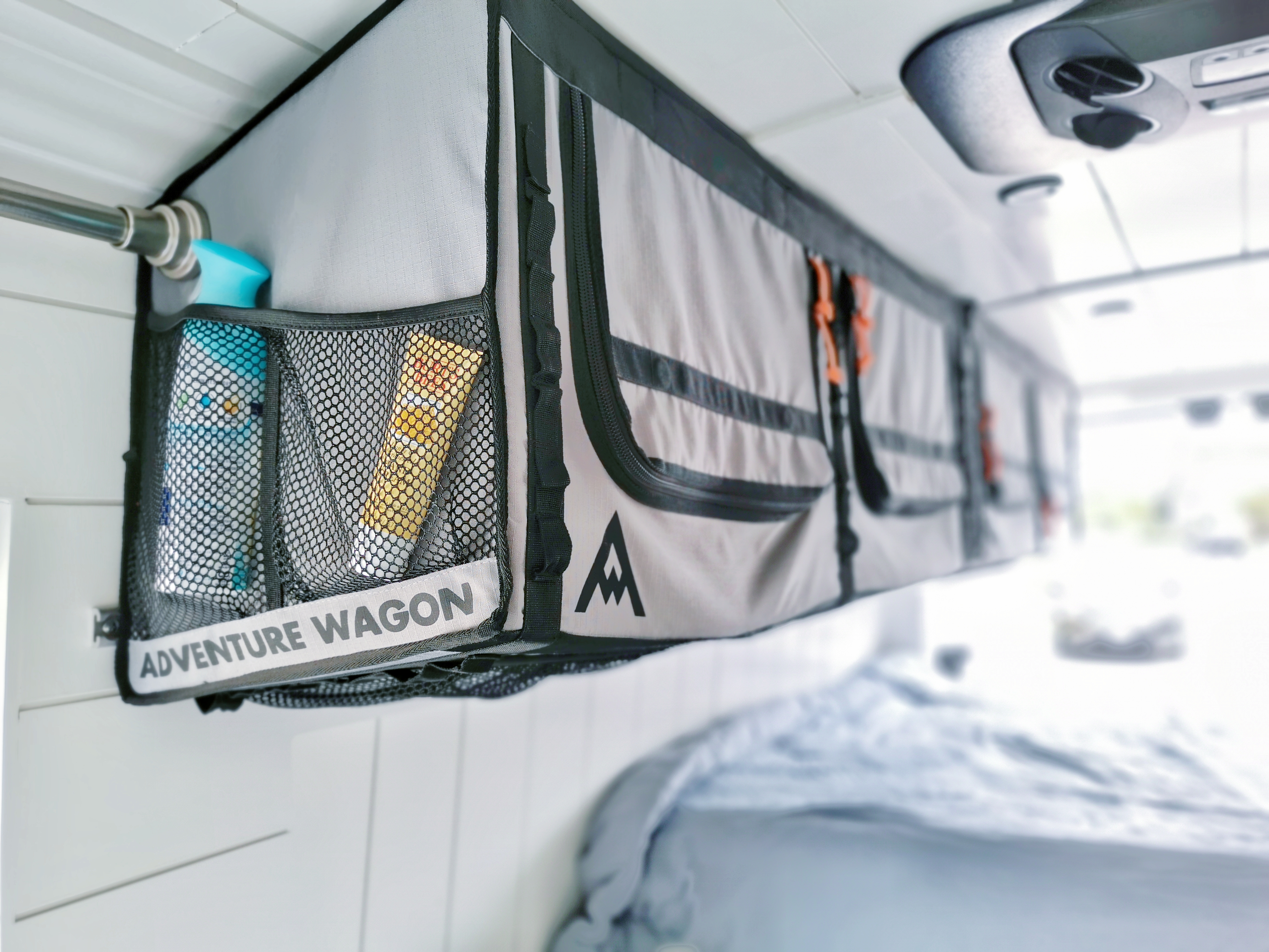 Stay organized in your RV rental: an "Adventure Wagon" overhead storage unit keeps toiletries and essentials tidy in this camper van.. Ford Transit 2020