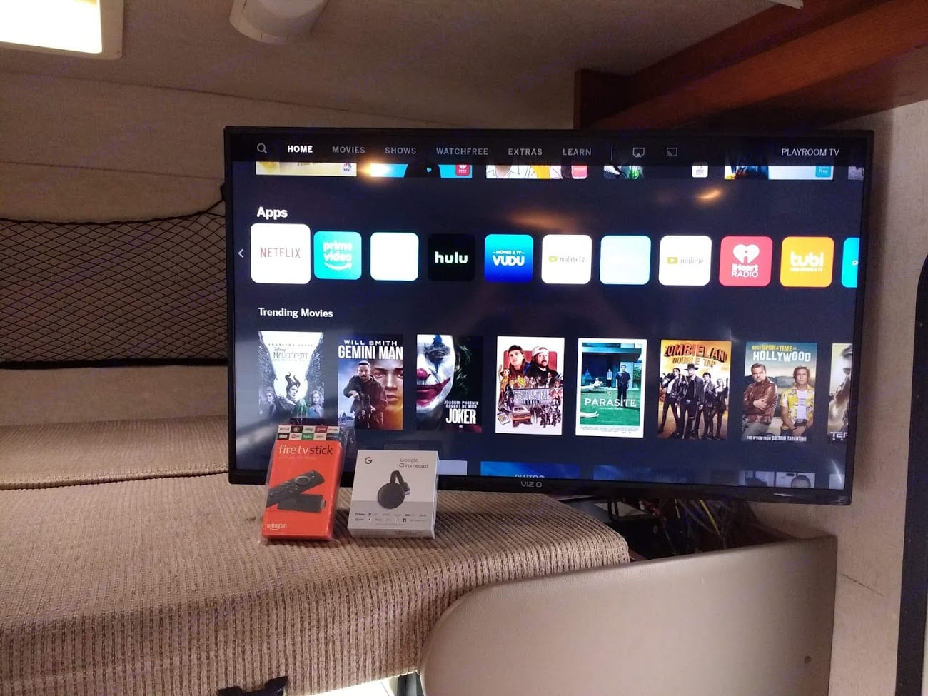 Inside an RV rental: smart TV shows streaming apps & movies. Fire TV Stick & Chromecast devices are on the bed.. Forest River Sunseeker LE 2014