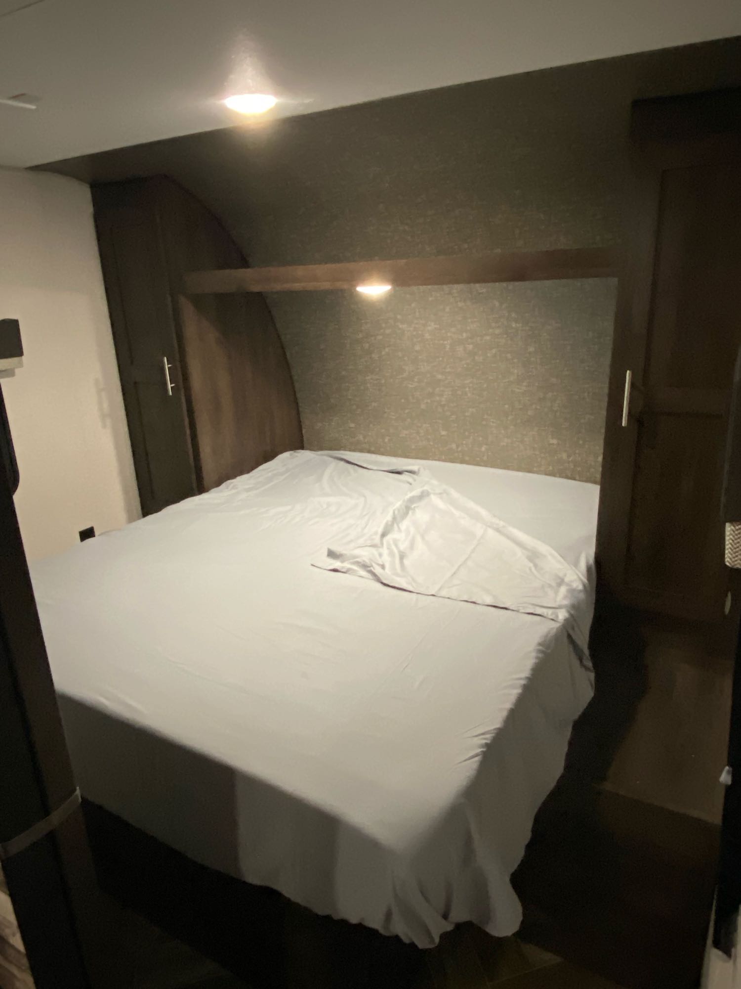 RV rental bedroom: cozy, compact, with built-in storage & soft lighting, perfect for travel.. K-Z Manufacturing Sportsmen 2021