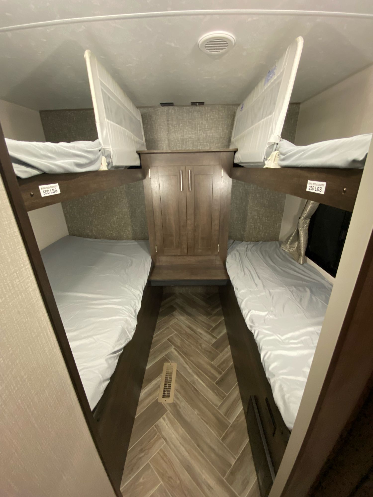 Inside this RV rental, find a comfortable sleeping area with four bunk beds. Two bunks on each side feature light sheets and safety nets.. K-Z Manufacturing Sportsmen 2021
