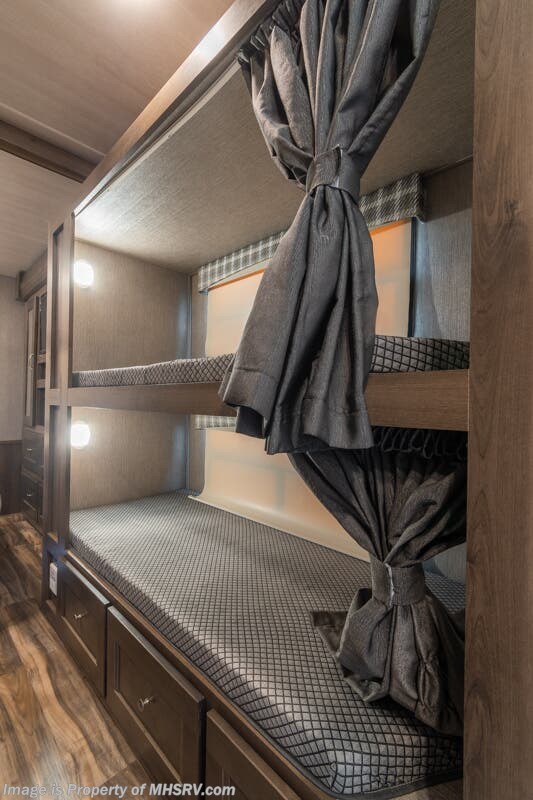 Cozy RV rental bunk beds with privacy curtains, built-in lighting, and storage drawers. Perfect for families.. Nexus Rebel 2022