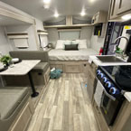 The interior of a clean rv rental, showing a comfortable bed, dinette, and kitchen. Ideal for travel accommodation.. Forest River Rockwood GeoPro 20BHS 2021