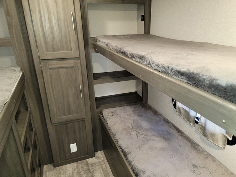 Explore this RV rental's comfy bunk beds and smart storage. Ideal for family trips, a compact mobile living space.. Other Other 2021