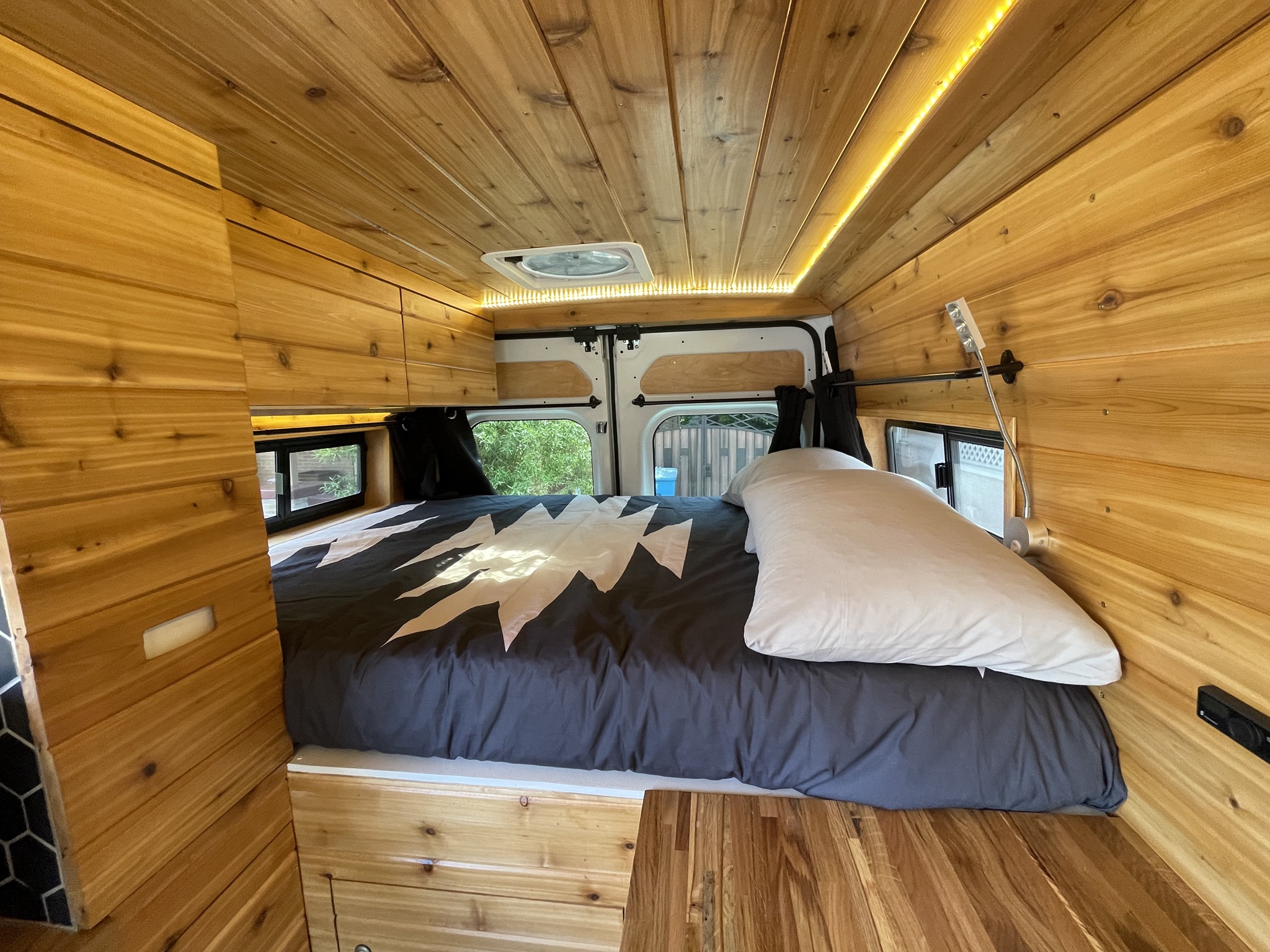 Gus has a full-sized memory foam bed with reading lamps and overhead storage. There's also a pull-out pantry (right). . Other Other 2021