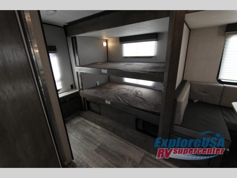 RV rental interior: two bunk beds & a U-shaped dinette with modern finishes.. Heartland North Trail 2021