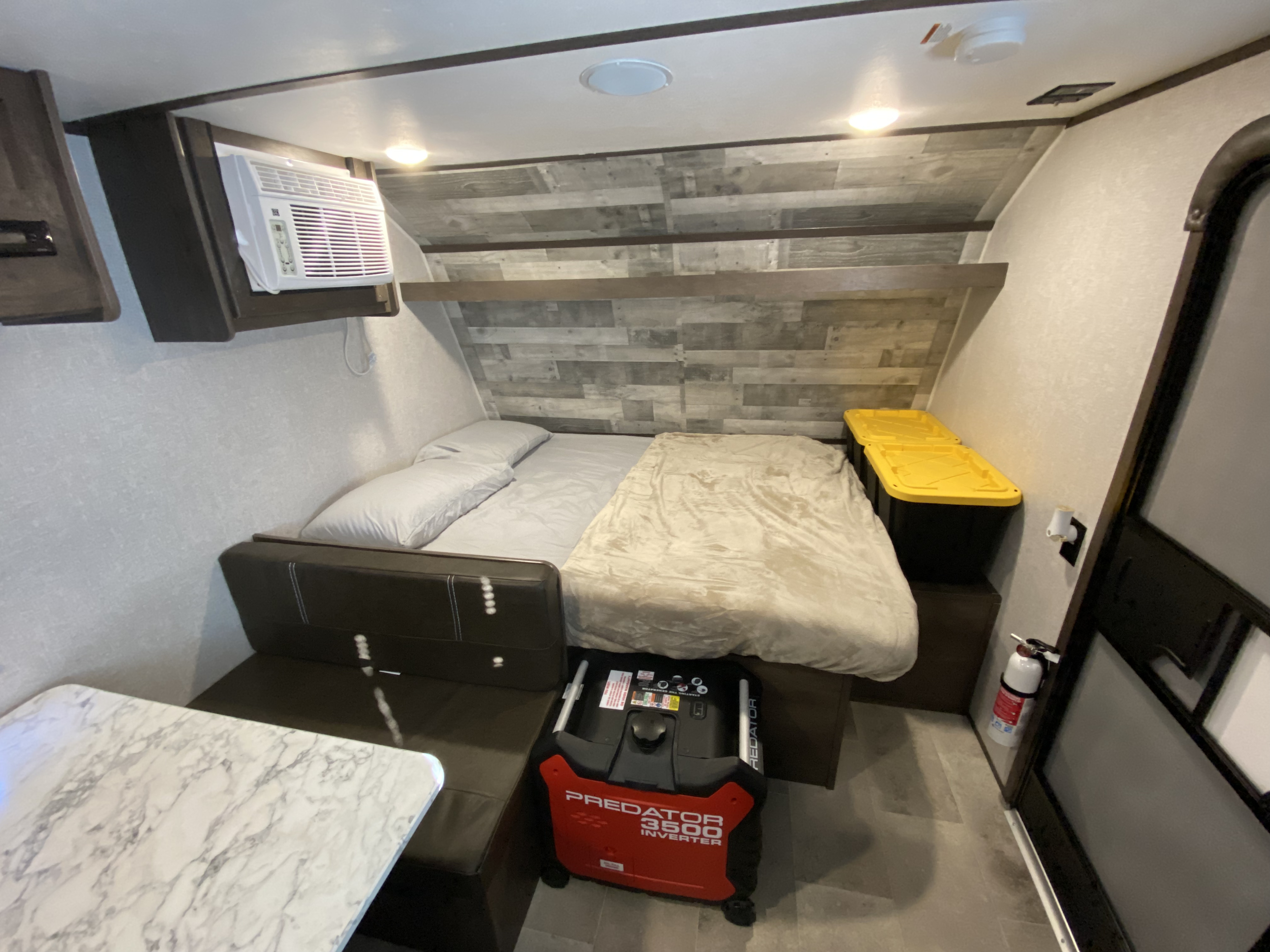 This rv rental features a cozy bed, wall-mounted AC, Predator generator, dining table, and storage bins for your trip.. Coleman Lantern 17 B 2022