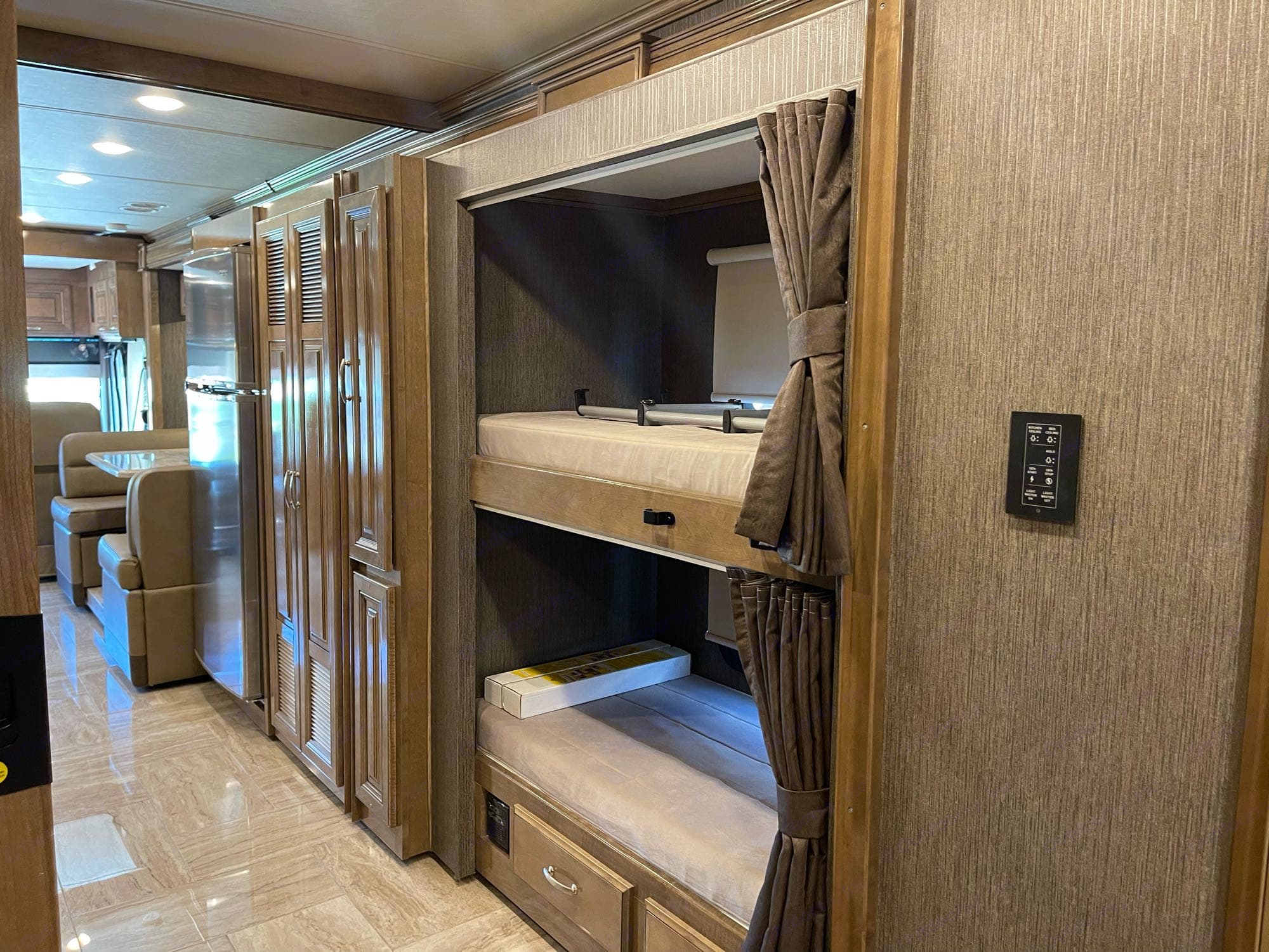 Experience an RV rental with these comfortable bunk beds, featuring privacy curtains & a sleek interior.. Thor Motor Coach Aurora 2020