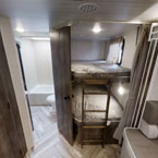 RV rental interior: A family-friendly travel trailer featuring bunk beds and a compact bathroom, perfect for adventure.. Forest River Wildwood X-Lite 2022