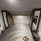 RV rental main bedroom: modern, comfy queen bed, integrated nightstands & mirrored storage for a restful trip.. Forest River Wildwood X-Lite 2022