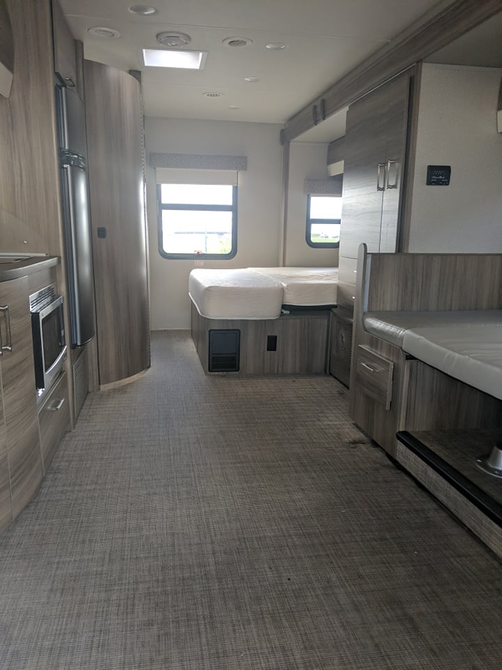 Explore this modern RV rental interior featuring a convertible bed, kitchen, and dinette. Your home away from home.. Jayco Melbourne 2018
