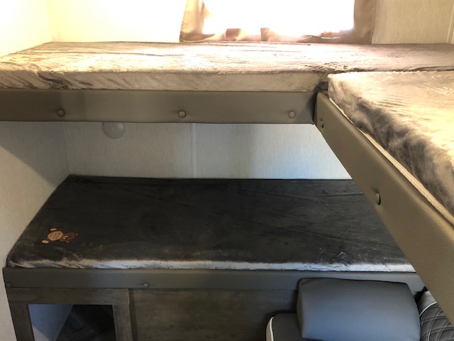 RV rental interior: cozy stacked bunk beds with plush bedding, perfect for comfortable family sleeping during travel.. Forest River Salem 2022