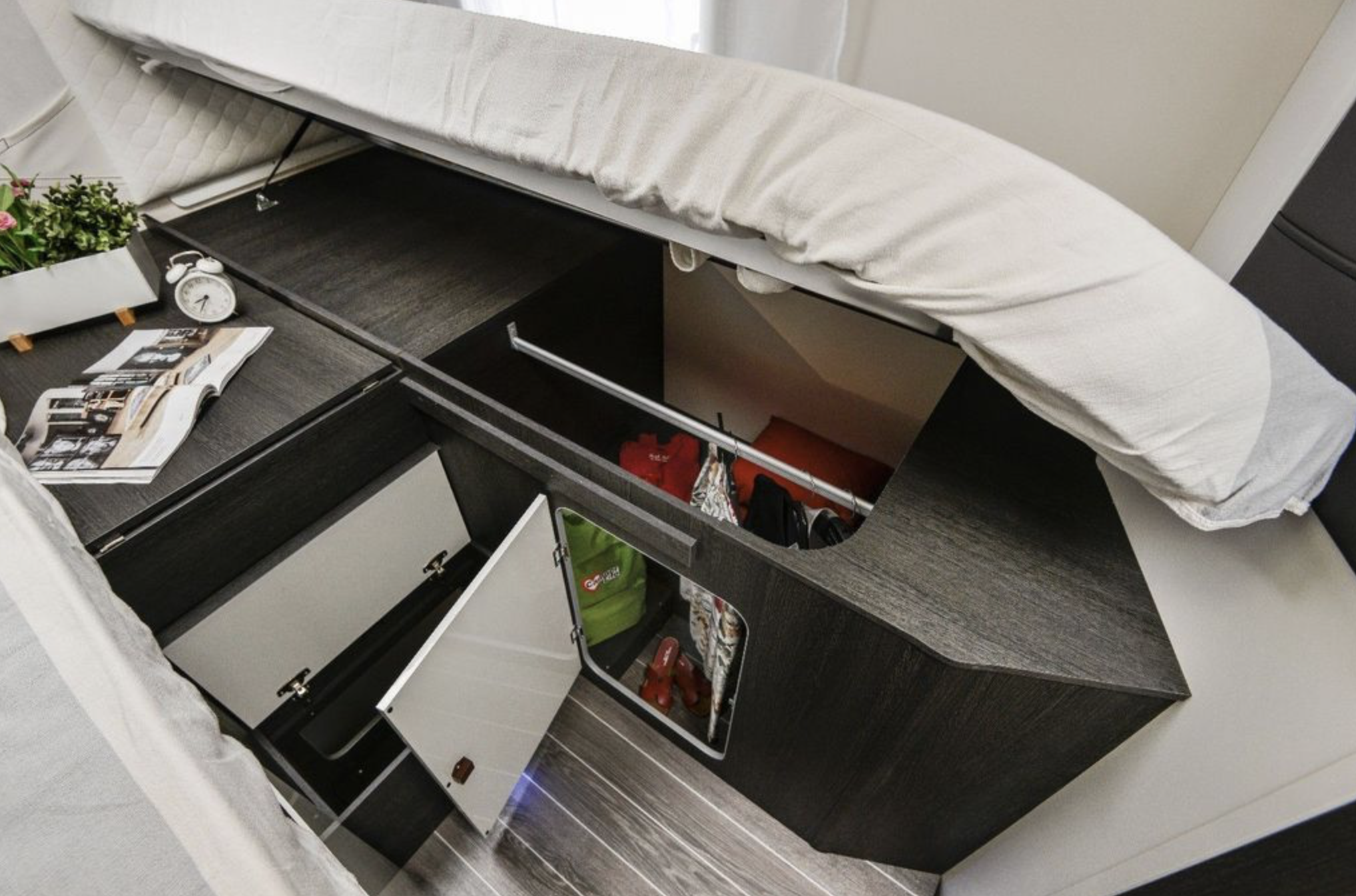 RV rental bed storage: smart interior, multiple compartments for clothes & gear, with bedside table and magazine.. Roller Team 685 Zefiro 2022