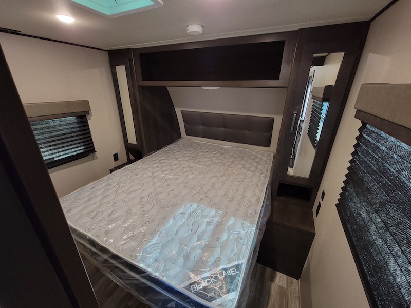 Experience comfort in this RV rental bedroom: bed with new mattress, mirrored wardrobe, and ample storage for your journey.. Other Other 2021