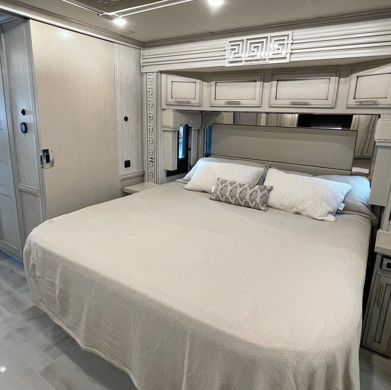 RV rental bedroom with a comfortable queen bed, stylish built-in overhead storage, and light-toned interior.. Other Ventana 2022