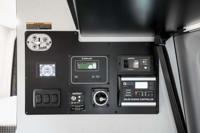 RV rental's central control panel, managing power, solar, water levels, and the EuroLoft drop-down bed.. Winnebago Revel 2023