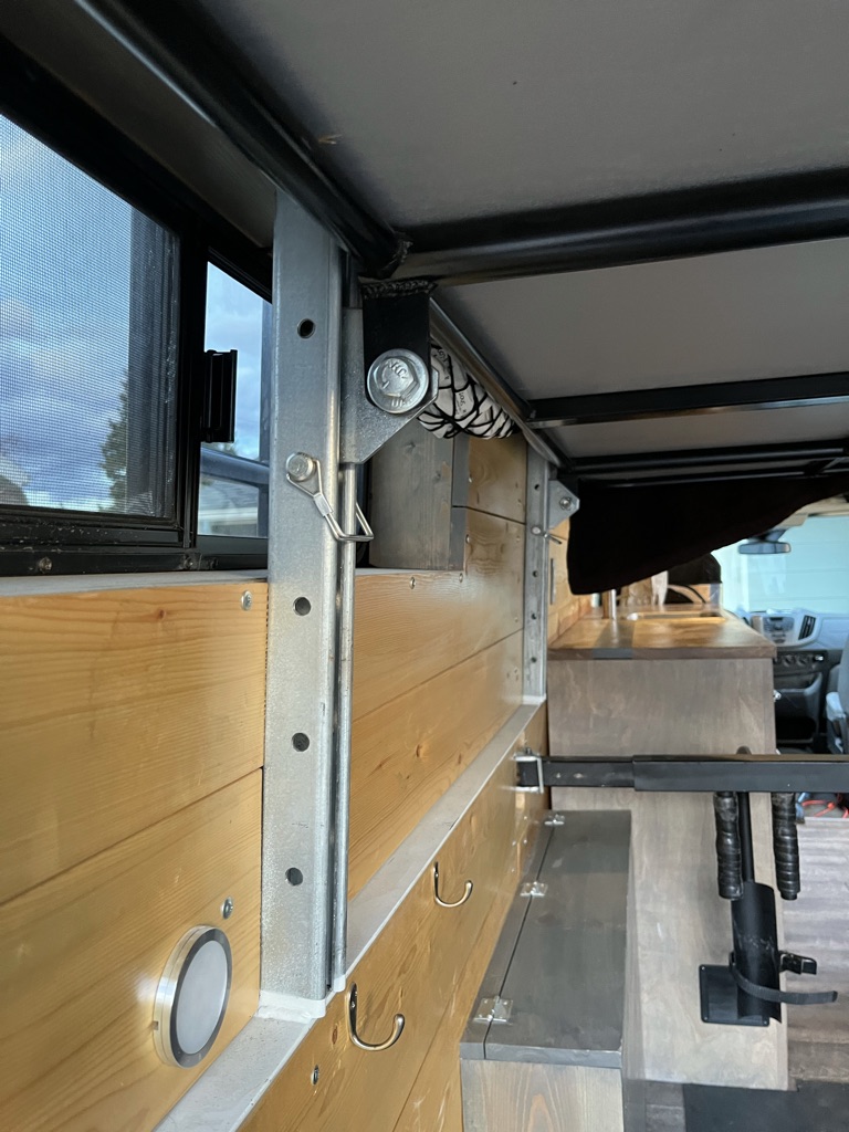 Experience an RV rental! This image shows the custom camper van interior with wooden walls, metal frame, and practical storage hooks.. Ford Transit Custom 2018