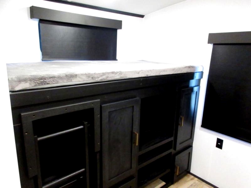 Inside an RV rental: modern bunk bed with integrated storage, a ladder, and dark window blinds.. Keystone Outback 340 BH 2022