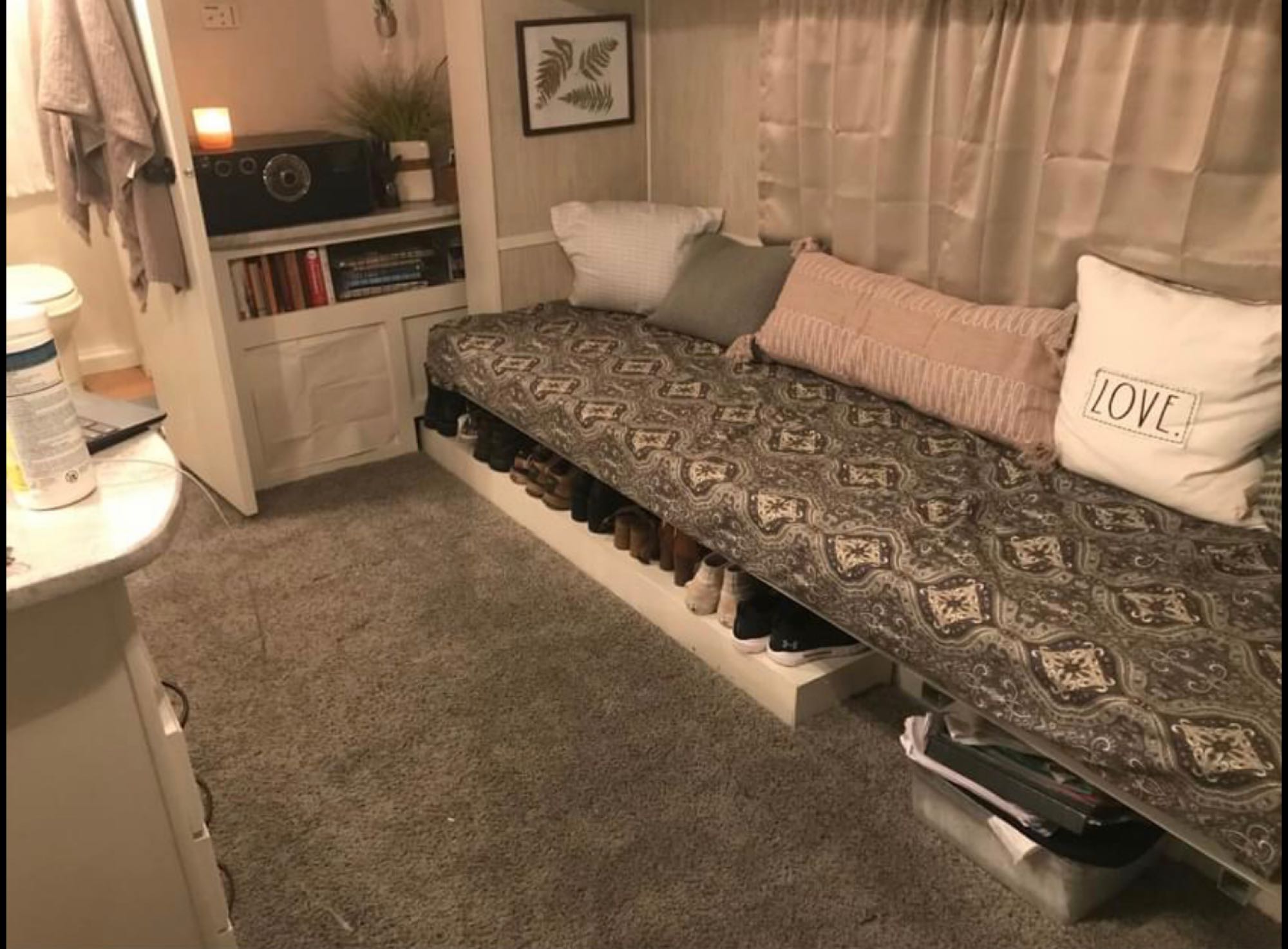 This RV rental offers practical small space solutions: a cozy daybed, under-bed shoe storage, and built-in shelving.. Heartland North Trail 2009