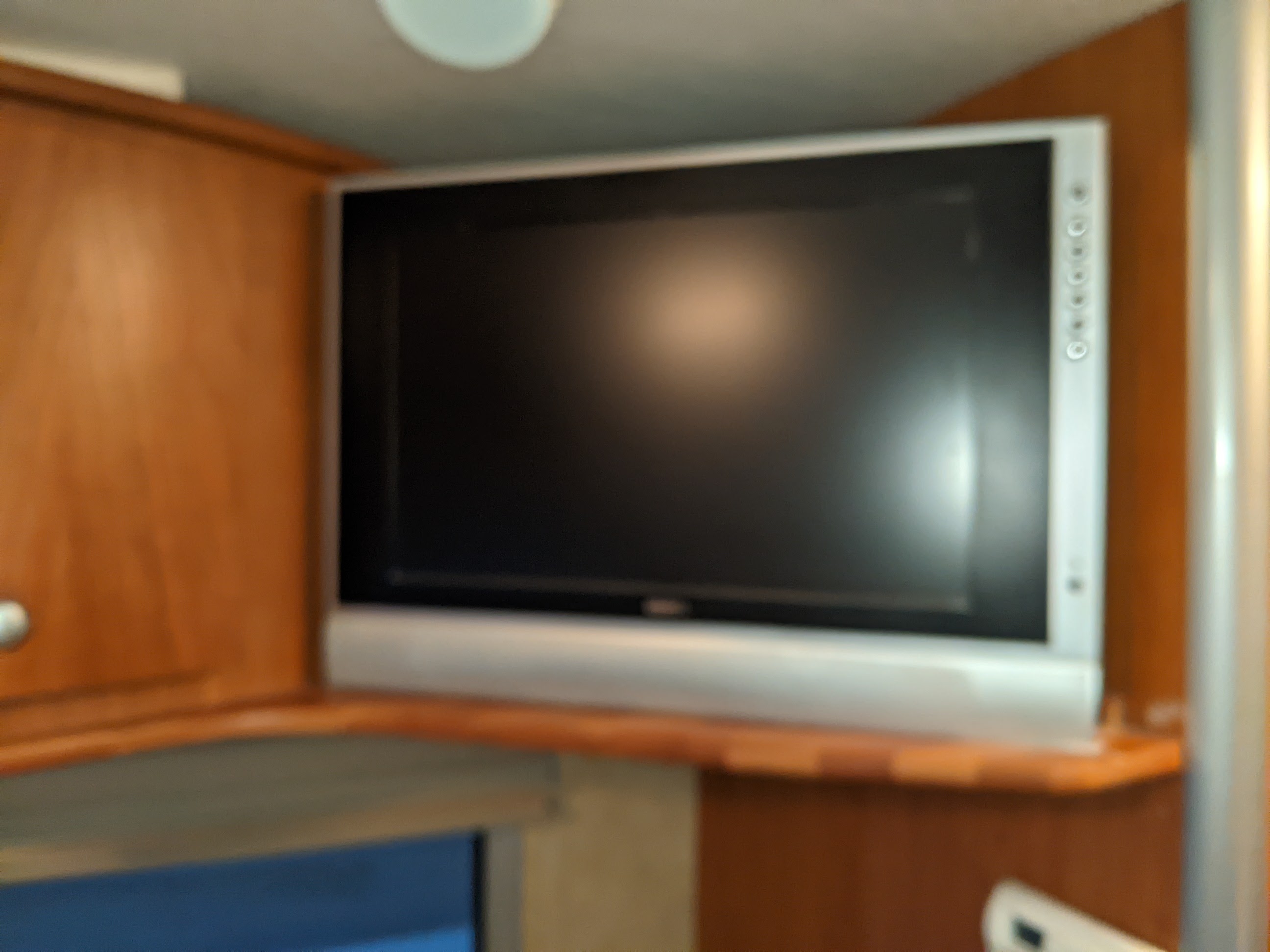 This RV rental offers a flat-screen TV on a wooden shelf, providing entertainment for your travels.. Winnebago Itasca Navion 2008