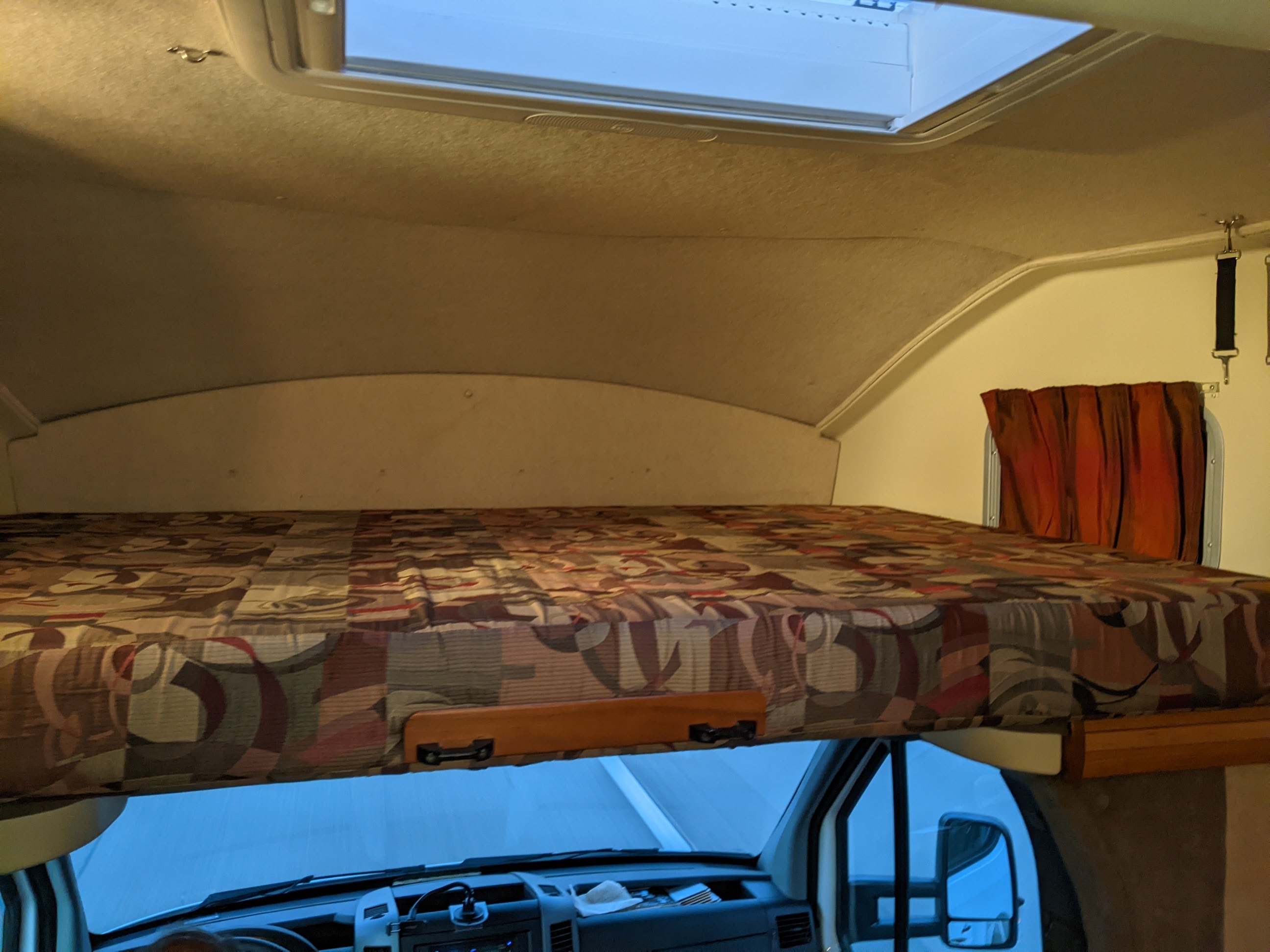 This RV rental features a comfortable cab-over bunk bed with a skylight and privacy curtain, ideal for travelers.. Winnebago Itasca Navion 2008
