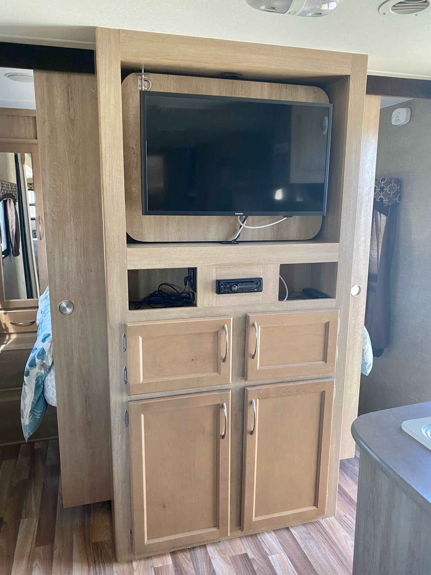 This RV rental's interior features an entertainment unit with TV, stereo, and storage, plus a sliding partition to the bedroom.. Pacific Coachworks Other 2016